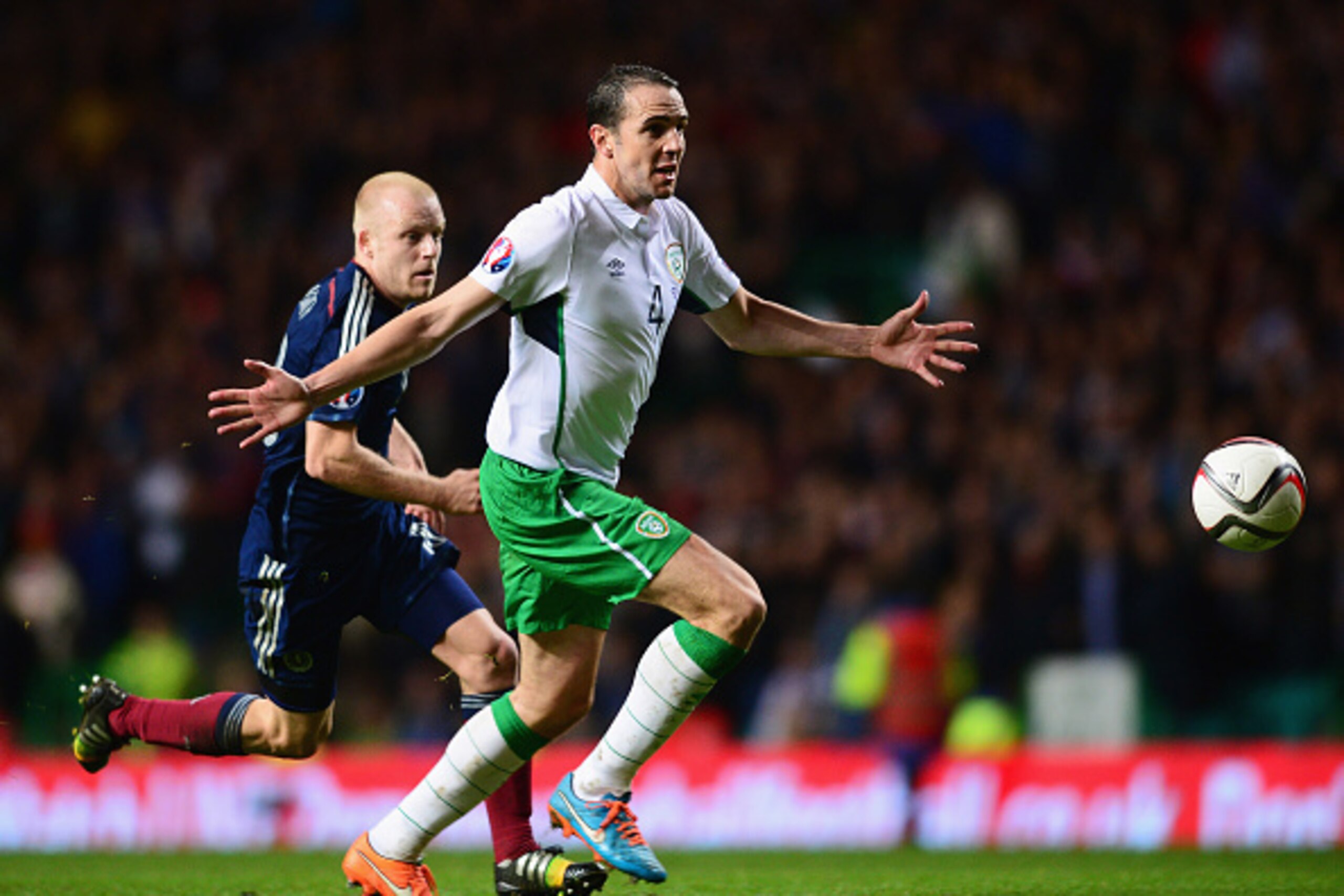 GLASGOW, SCOTLAND - NOVEMBER 14:  John O'Shea of the Republic of Ireland shields the ball from Steven Naismith of Scotland during the EURO 2016 Group D Qualifier match between Scotland and Republic of Ireland at Celtic Park on November 14, 2014 in Glasgow