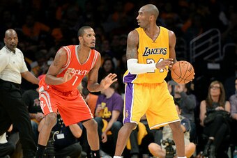 LOS ANGELES, CA - OCTOBER 28: Kobe Bryant #24 of the Los Angeles Lakers handles the ball against Trevor Ariza #1 of the Houston Rockets on October 28, 2014 at the Staples Center in Los Angeles, California. NOTE TO USER: User expressly acknowledges and agr