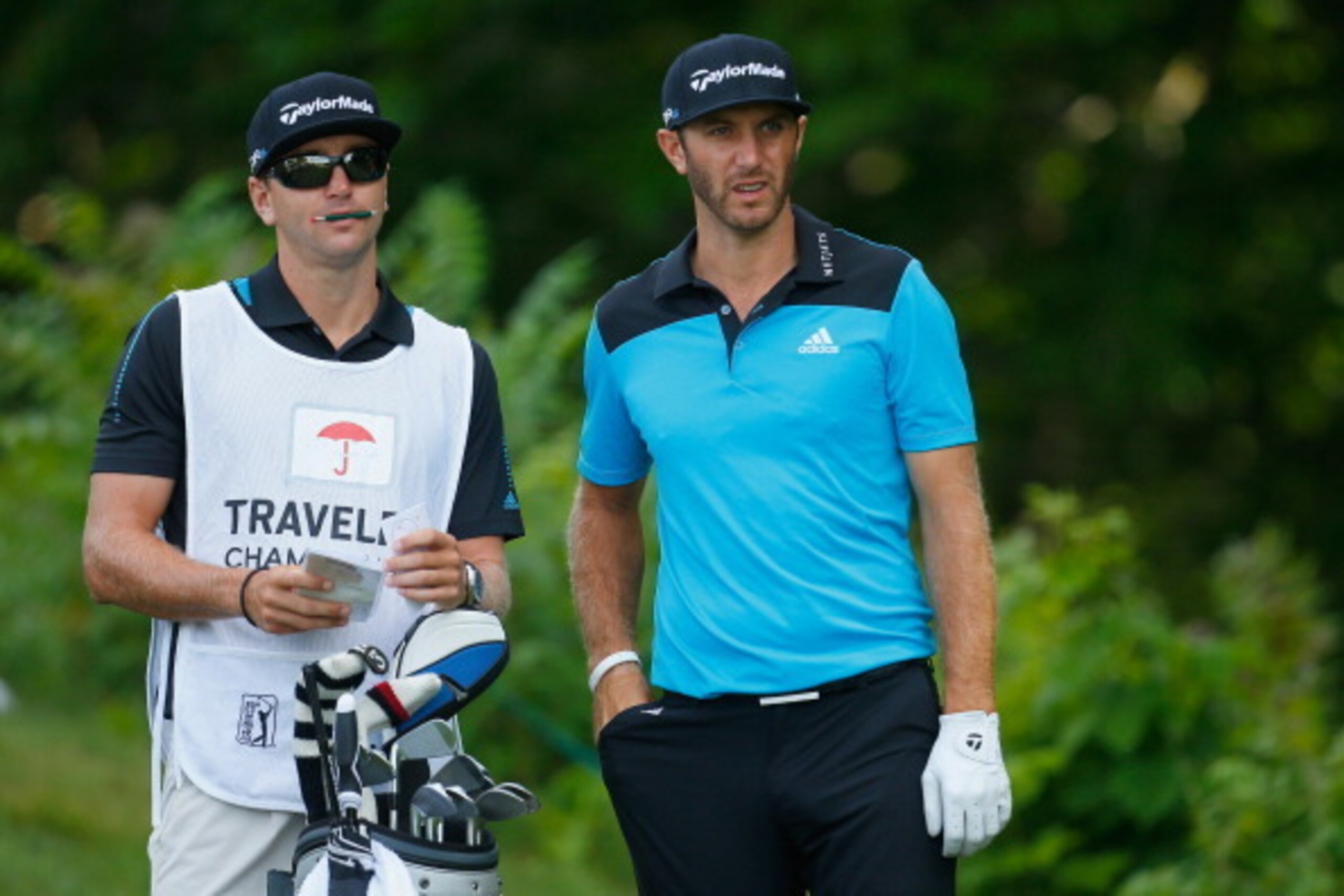 CROMWELL, CT - JUNE 20: Dustin Johnson of the United States and his caddie Austin Johnson talk on the 12th tee during the second round of the Travelers Championship golf tournament at the TPC River Highlands on June 20, 2014 in Cromwell, Connecticut. (Ph CROMWELL, CT - JUNE 20: Dustin Johnson of the United States and his caddie Austin Johnson talk on the 12th tee during the second round of the Travelers Championship golf tournament at the TPC River Highlands on June 20, 2014 in Cromwell, Connecticut. (Ph