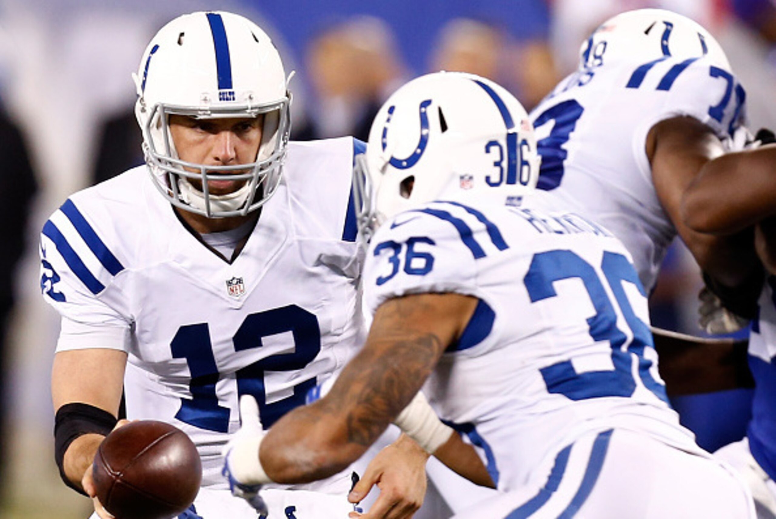 EAST RUTHERFORD, NJ - NOVEMBER 03:  Andrew Luck #12 of the Indianapolis Colts hands the ball off to Dan Herron #36  against New York Giants during their game at MetLife Stadium on November 3, 2014 in East Rutherford, New Jersey.  (Photo by Jeff Zelevansky
