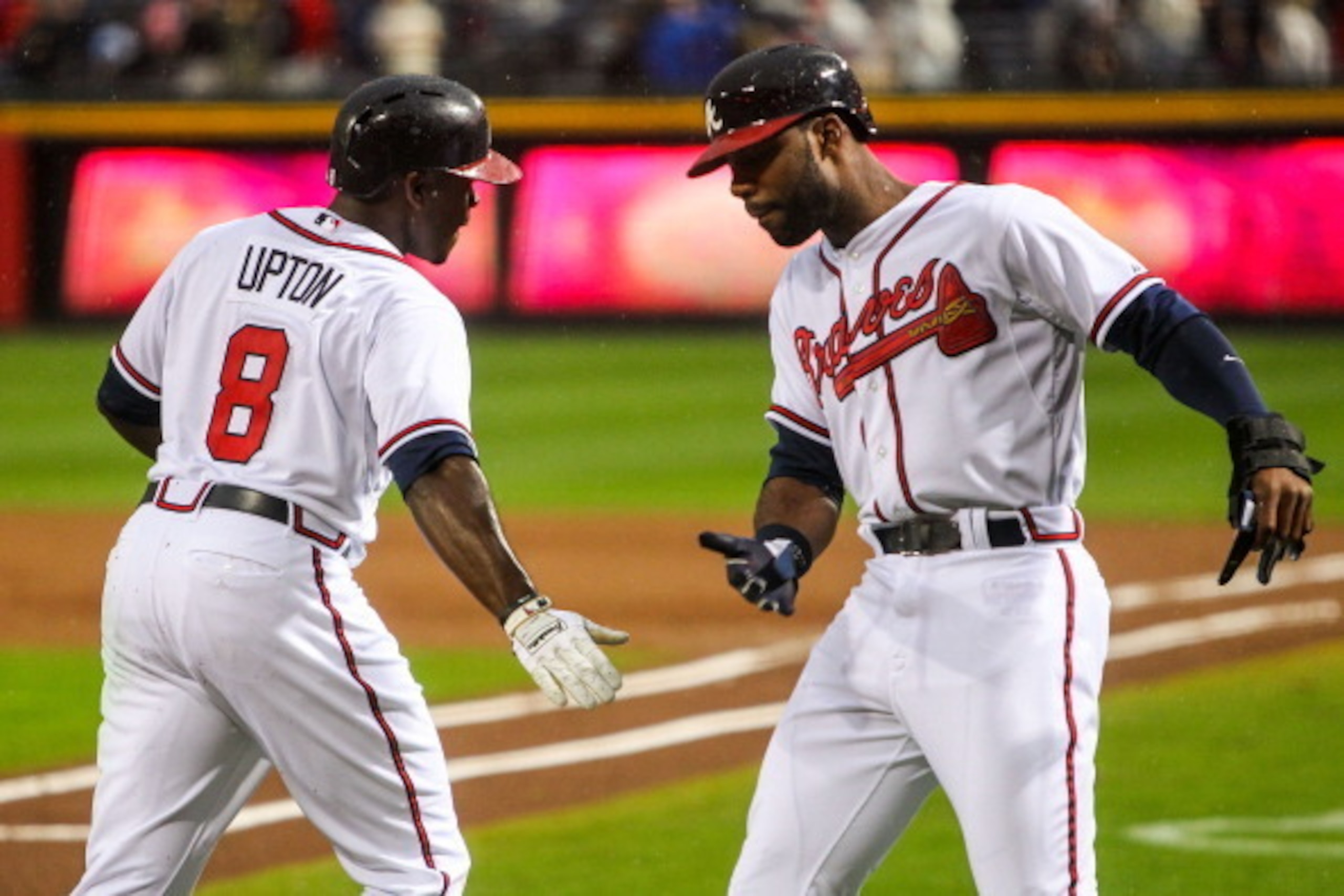 ATLANTA, GA - APRIL 3:  Justin Upton #8 celebrates a two-run home run with Jason Heyward #22 of the Atlanta Braves in the first inning of the game against the Philadelphia Phillies at Turner Field on April 3, 2013 in Atlanta, Georgia.  (Photo by Daniel Sh