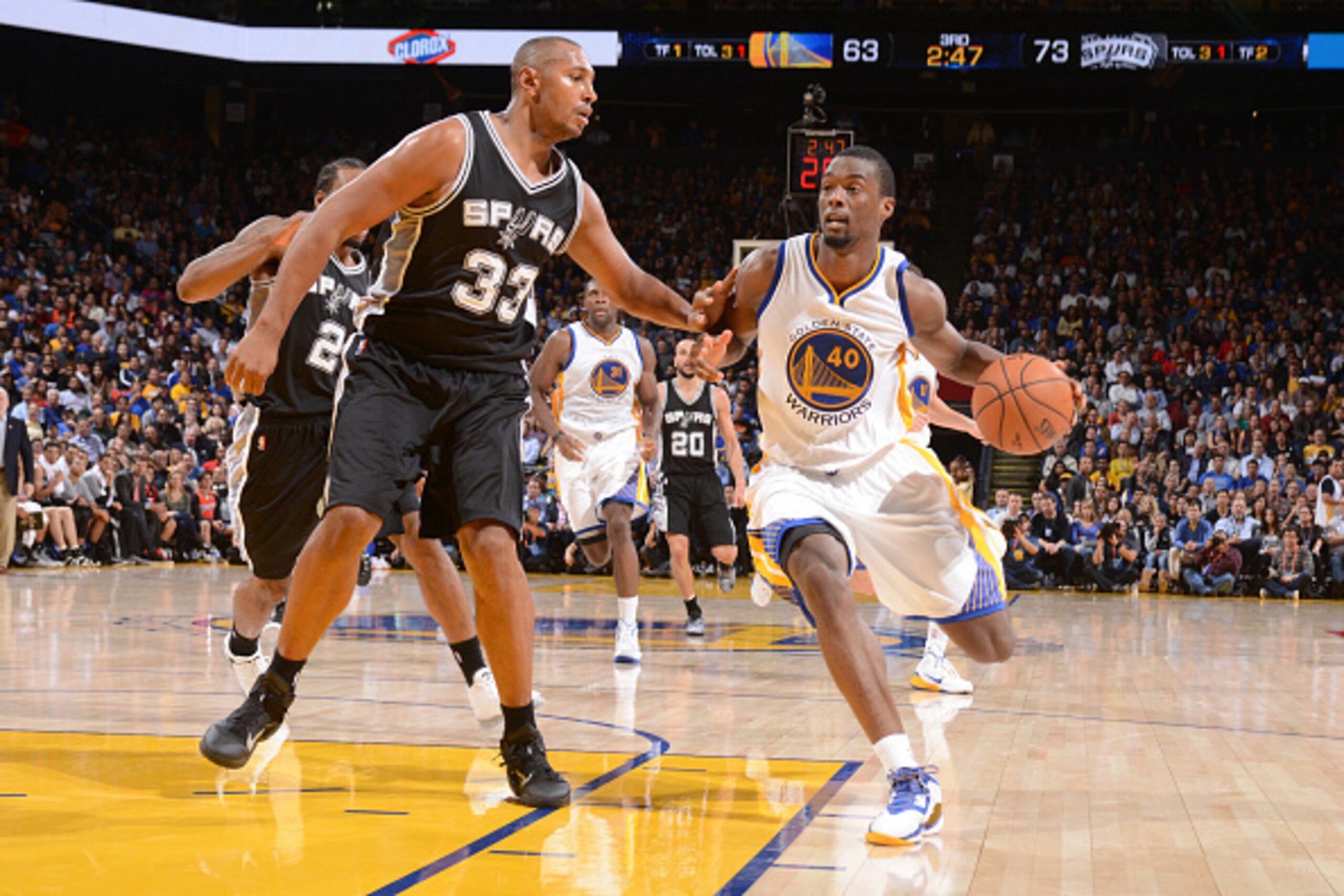 OAKLAND, CA - NOVEMBER 11: Harrison Barnes #40 of the Golden State Warriors drives against Boris Diaw #33 of the San Antonio Spurs on November 11, 2014 at Oracle Arena in Oakland, California. NOTE TO USER: User expressly acknowledges and agrees that, by d