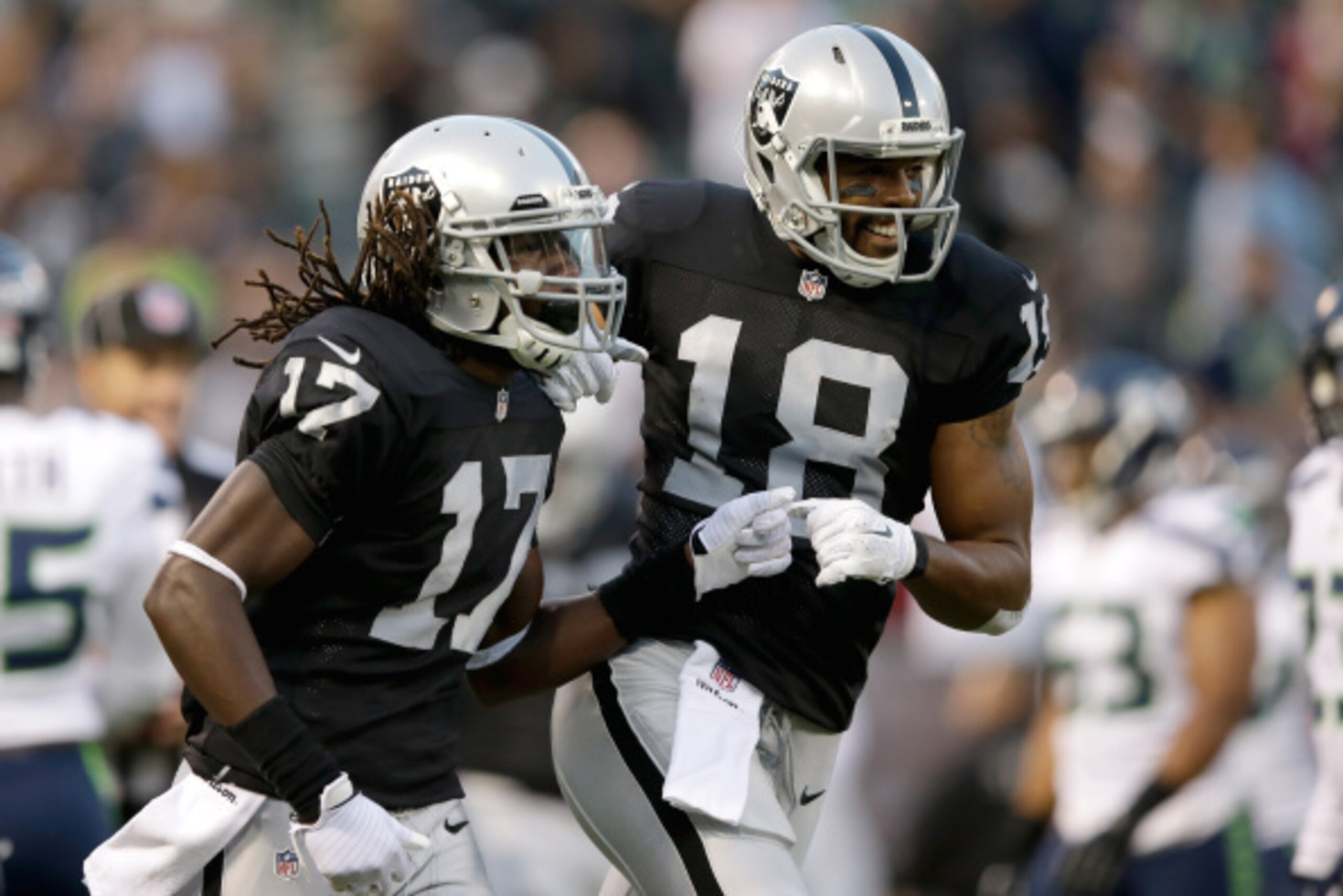 OAKLAND, CA - AUGUST 28: Wide receiver Denarius Moore #17 of the Oakland Raiders celebrates with wide receiver Andre Holmes #18 after scoring a touchdown against the Seattle Seahawks during a preseason game at O.co Coliseum on August 28, 2014 in Oakland, 
