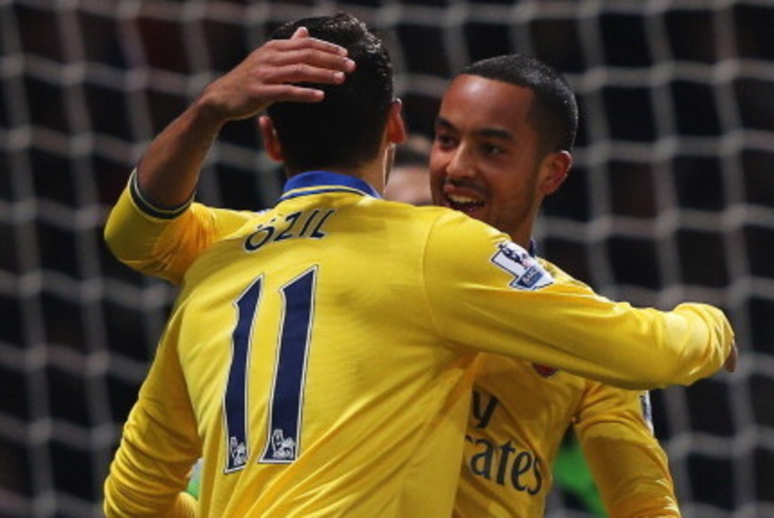 LONDON, ENGLAND - DECEMBER 26:  Theo Walcott of Arsenal (R) celebrates with Mesut Oezil (11) as he scores their first goal during the Barclays Premier League match between West Ham United and Arsenal at Boleyn Ground on December 26, 2013 in London, Englan