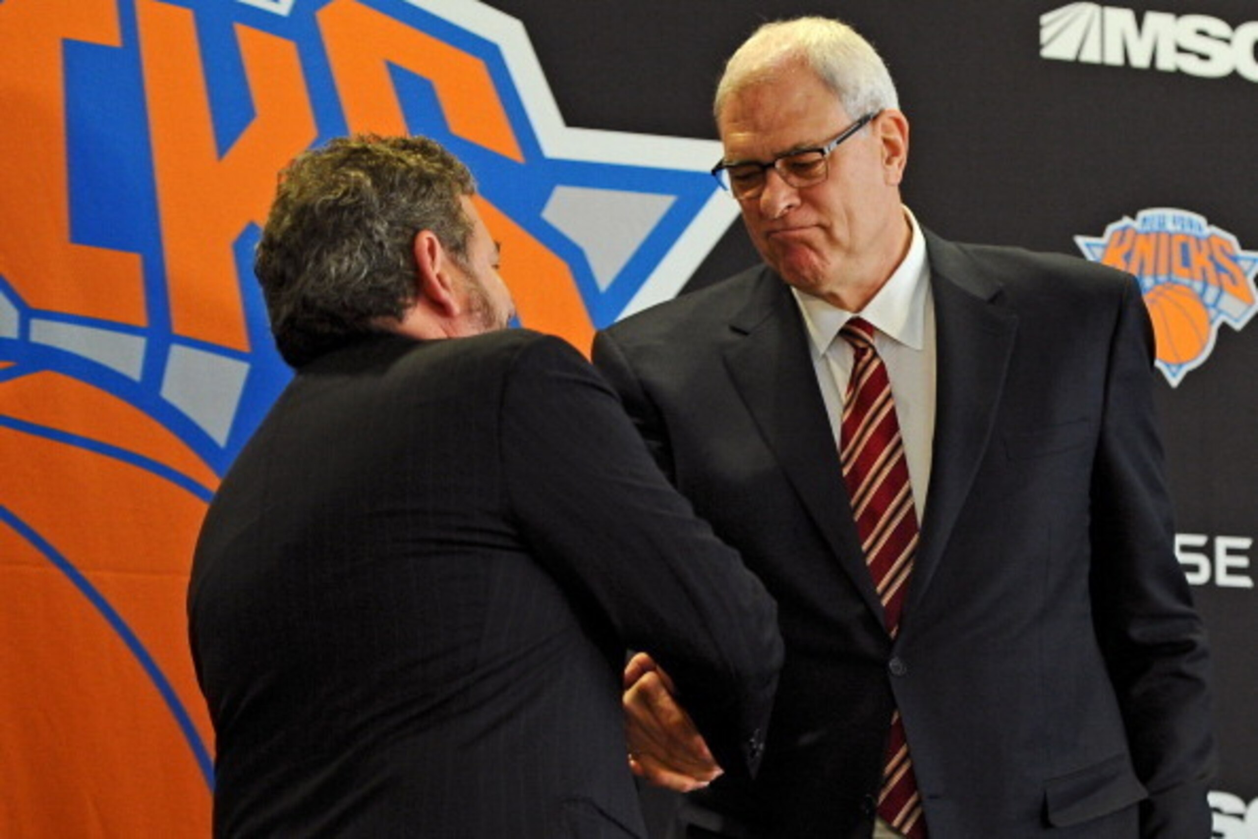 NEW YORK, NY - MARCH 18: Phil Jackson shakes hands with James Dolan, Executive Chairman of Maidson Square Garden, during his introductory press conference as President of the New York Knicks at Madison Square Garden on March 18, 2014 in New York City.  (P