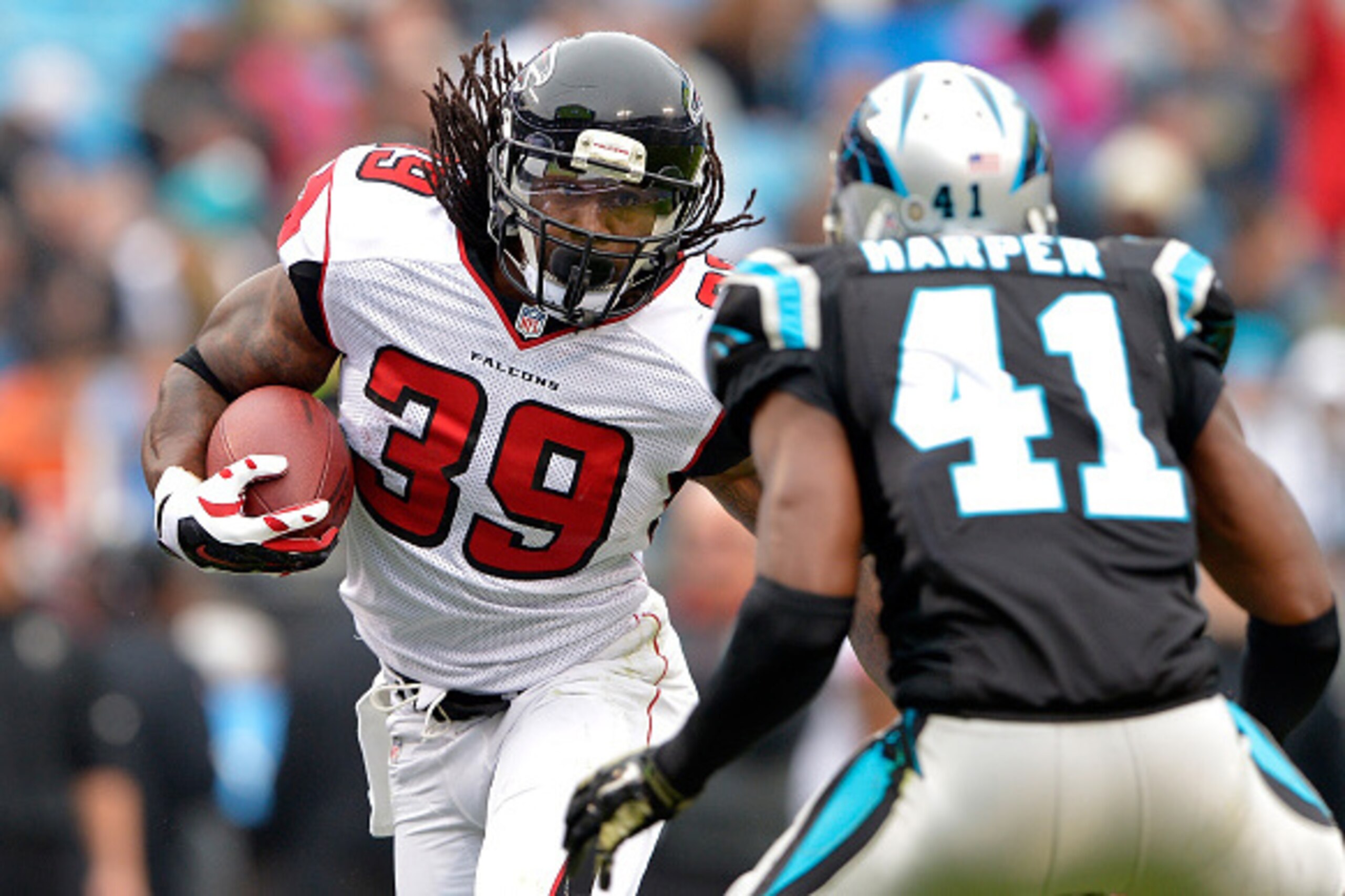 CHARLOTTE, NC - NOVEMBER 16:  Steven Jackson #39 of the Atlanta Falcons runs the ball against Roman Harper #41 of the Carolina Panthers in the 2nd half during their game at Bank of America Stadium on November 16, 2014 in Charlotte, North Carolina.  (Photo