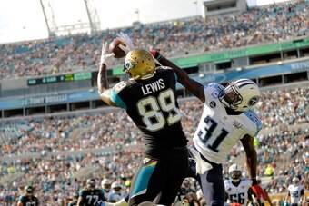 JACKSONVILLE, FL - DECEMBER 22:  Marcedes Lewis #89 of the Jacksonville Jaguars catches a touchdown pass over Bernard Pollard #31 of the Tennessee Titans during a game at EverBank Field on December 22, 2013 in Jacksonville, Florida.  (Photo by Stacy Rever
