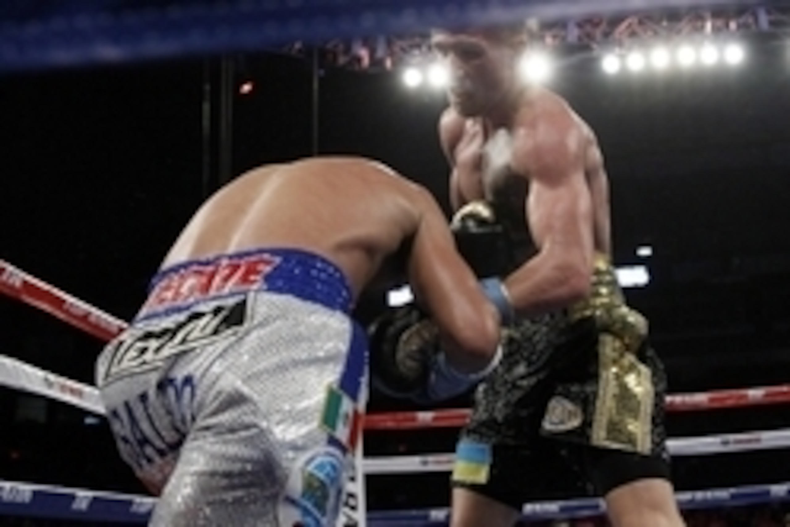 Mar 1, 2014; San Antonio, TX, USA; Orlando Salido (white trunks) trades punches with Vasyl Lomachenko (black trunks) during their WBO world featherweight title bout at Alamodome. Mandatory Credit: Soobum Im-USA TODAY Sports