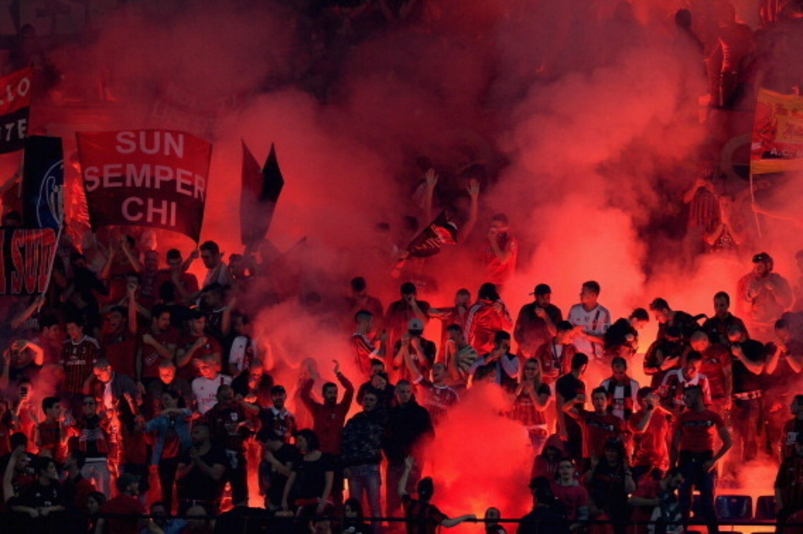 MILAN, ITALY - MAY 04:  AC Milan fans light firebombs during the Serie A match between AC Milan and FC Internazionale Milano at Stadio Giuseppe Meazza on May 4, 2014 in Milan, Italy.  (Photo by Claudio Villa/Getty Images)