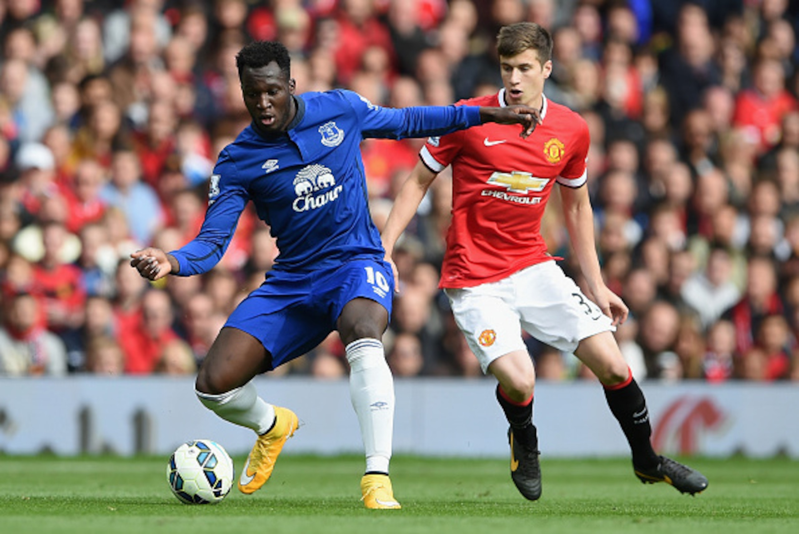 MANCHESTER, ENGLAND - OCTOBER 05:  Romelu Lukaku of Everton competes with Patrick McNair of Manchester United during the Barclays Premier League match between Manchester United and Everton at Old Trafford on October 5, 2014 in Manchester, England.  (Photo