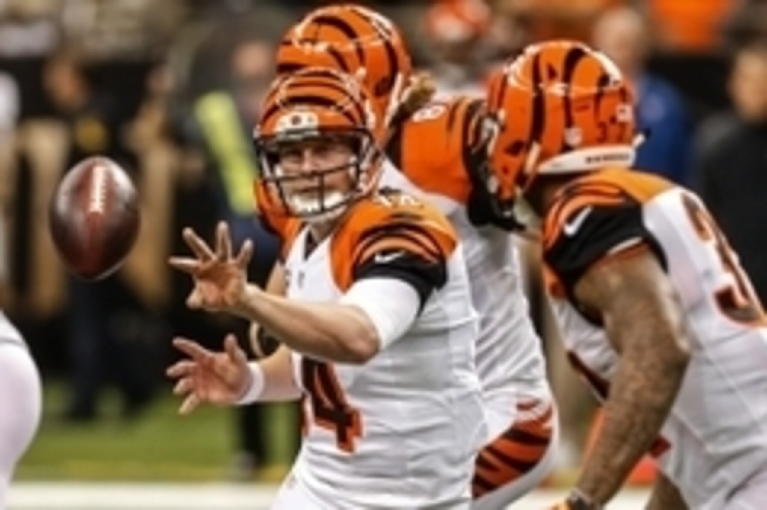 Nov 16, 2014; New Orleans, LA, USA; Cincinnati Bengals quarterback Andy Dalton (14) tosses the ball to running back Jeremy Hill (32) against the New Orleans Saints during the second half of a game at the Mercedes-Benz Superdome. The Bengals defeated the S