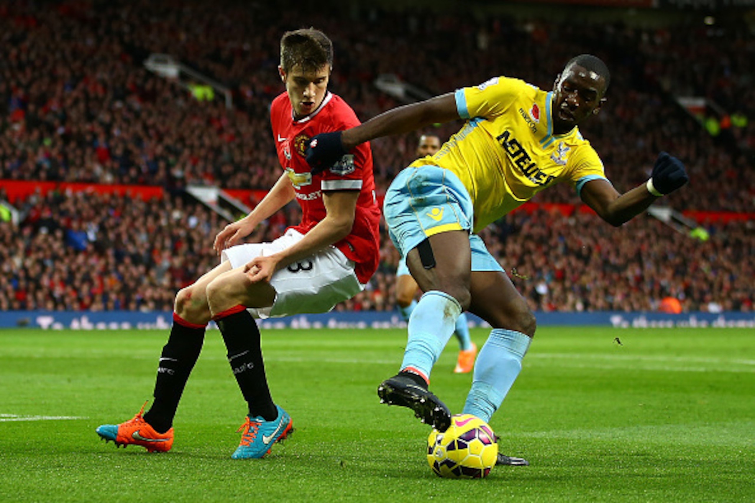 MANCHESTER, ENGLAND - NOVEMBER 08:  Patrick McNair of Manchester United competes with Yannick Bolasie of Crystal Palace during the Barclays Premier League match between Manchester United and Crystal Palace at Old Trafford on November 8, 2014 in Manchester