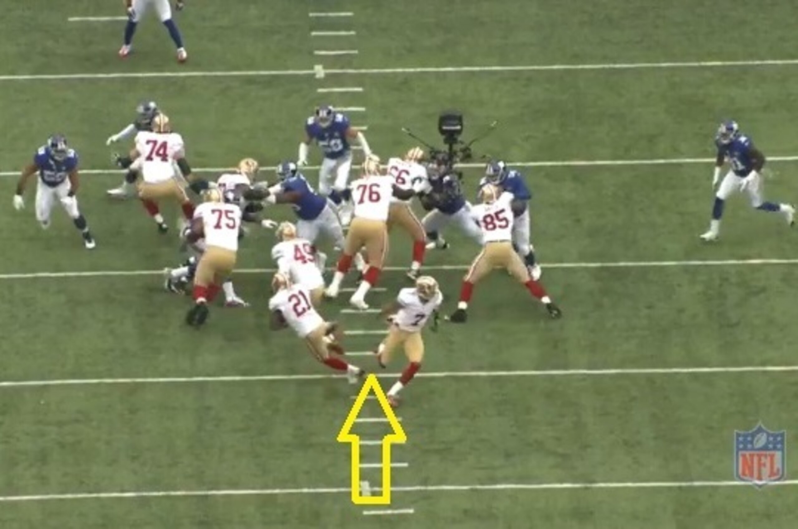 Gore trips over Kaepernick's foot, which causes him to lose his balance.