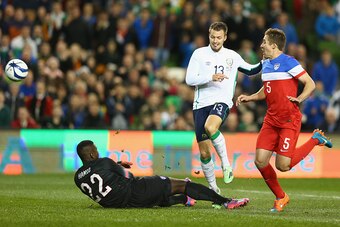 DUBLIN, IRELAND - NOVEMBER 18:  Anthony Pilkington (C) of Ireland lobs the ball over goalkeeper Bill Hamid of USA to score his sides opening goal during the International Friendly match between the Republic of Ireland and USA at the Aviva Stadium on Novem
