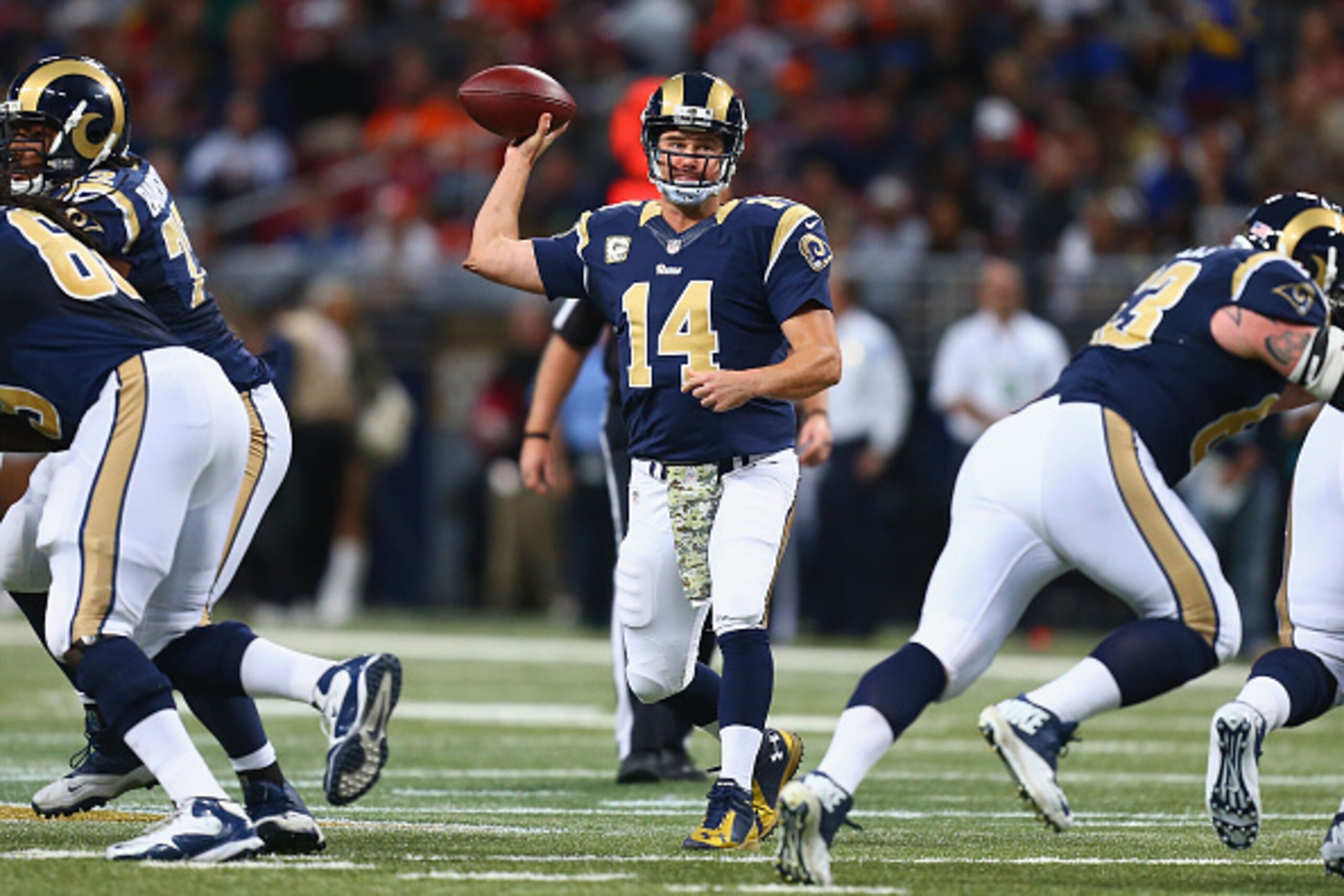 ST. LOUIS, MO - NOVEMBER 16: Shaun Hill #14 of the St. Louis Rams passes the ball against the Denver Broncos in the first quarter at the Edward Jones Dome on November 16, 2014 in St. Louis, Missouri.  The Rams beat the Broncos 22-7.  (Photo by Dilip Vishw