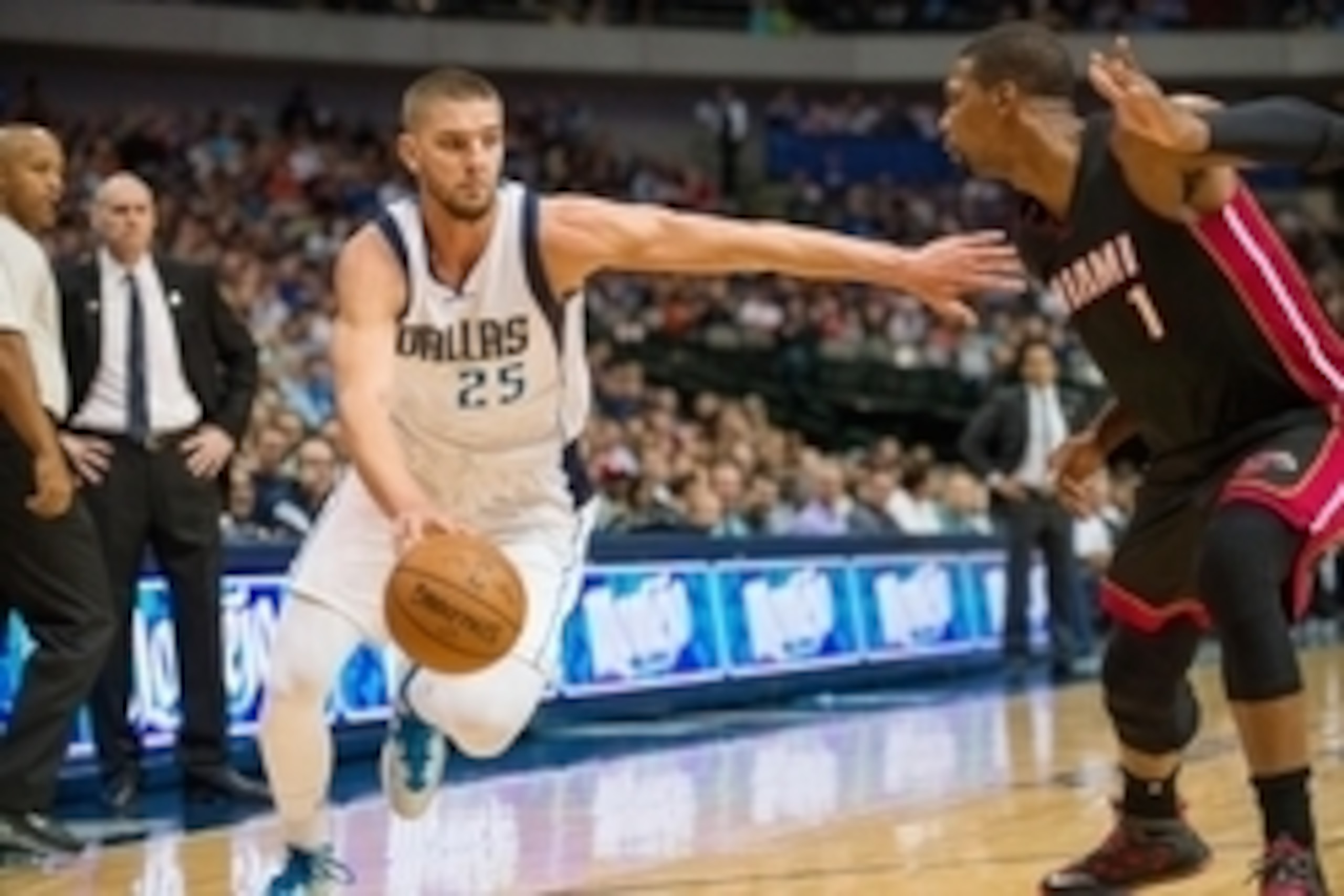 Nov 9, 2014; Dallas, TX, USA; Dallas Mavericks forward Chandler Parsons (25) drives to the basket past Miami Heat center Chris Bosh (1) during the first quarter at the American Airlines Center. Mandatory Credit: Jerome Miron-USA TODAY Sports