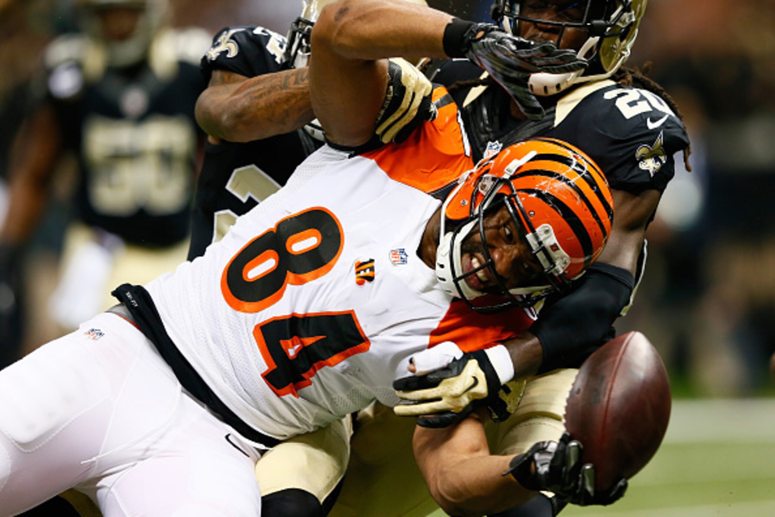 NEW ORLEANS, LA - NOVEMBER 16:  Corey White #24 of the New Orleans Saints forces a fumble by  Jermaine Gresham #84 of the Cincinnati Bengals but he recovers it for the touchdown during the first quarter at Mercedes-Benz Superdome on November 16, 2014 in N