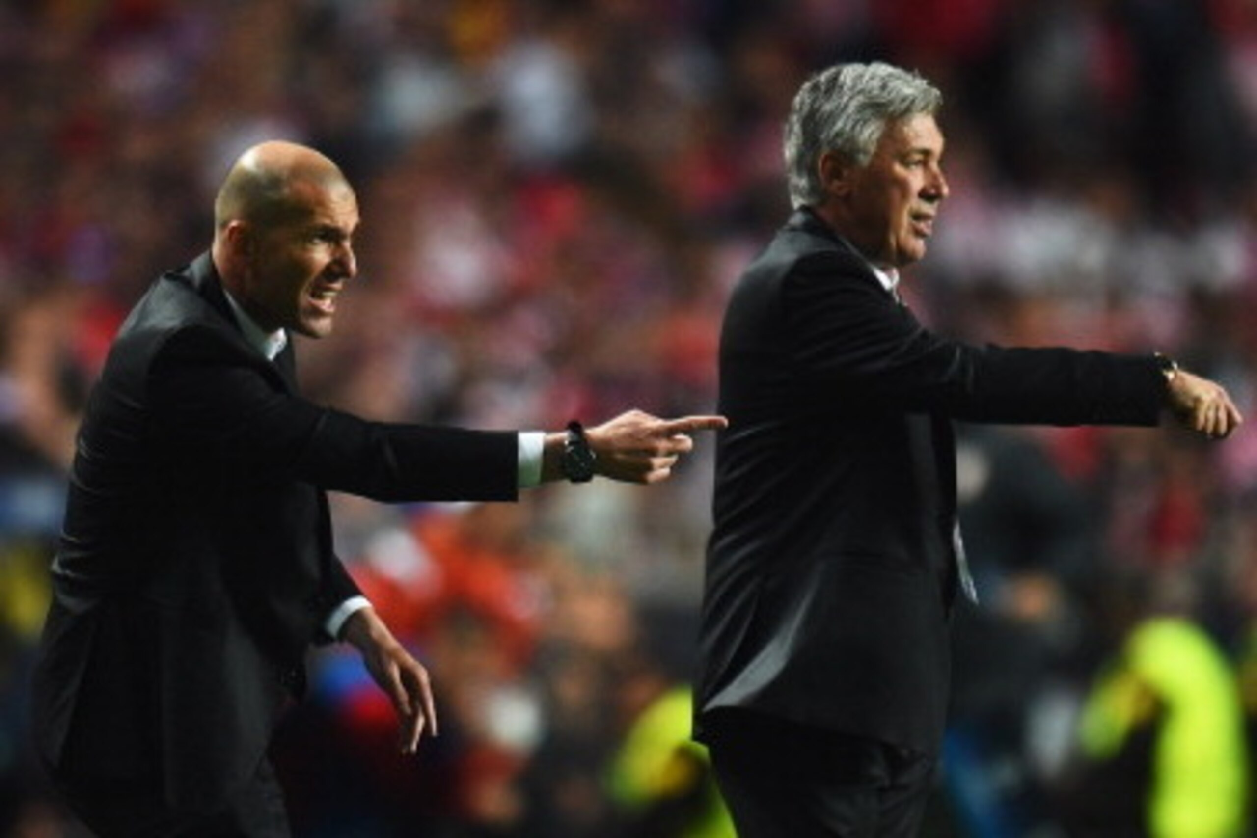 LISBON, PORTUGAL - MAY 24:  Zinedine Zidane (L) assistant manager of Real Madrid and Carlo Ancelotti manager of Real Madrid signal during the UEFA Champions League Final between Real Madrid and Atletico de Madrid at Estadio da Luz on May 24, 2014 in Lisbo
