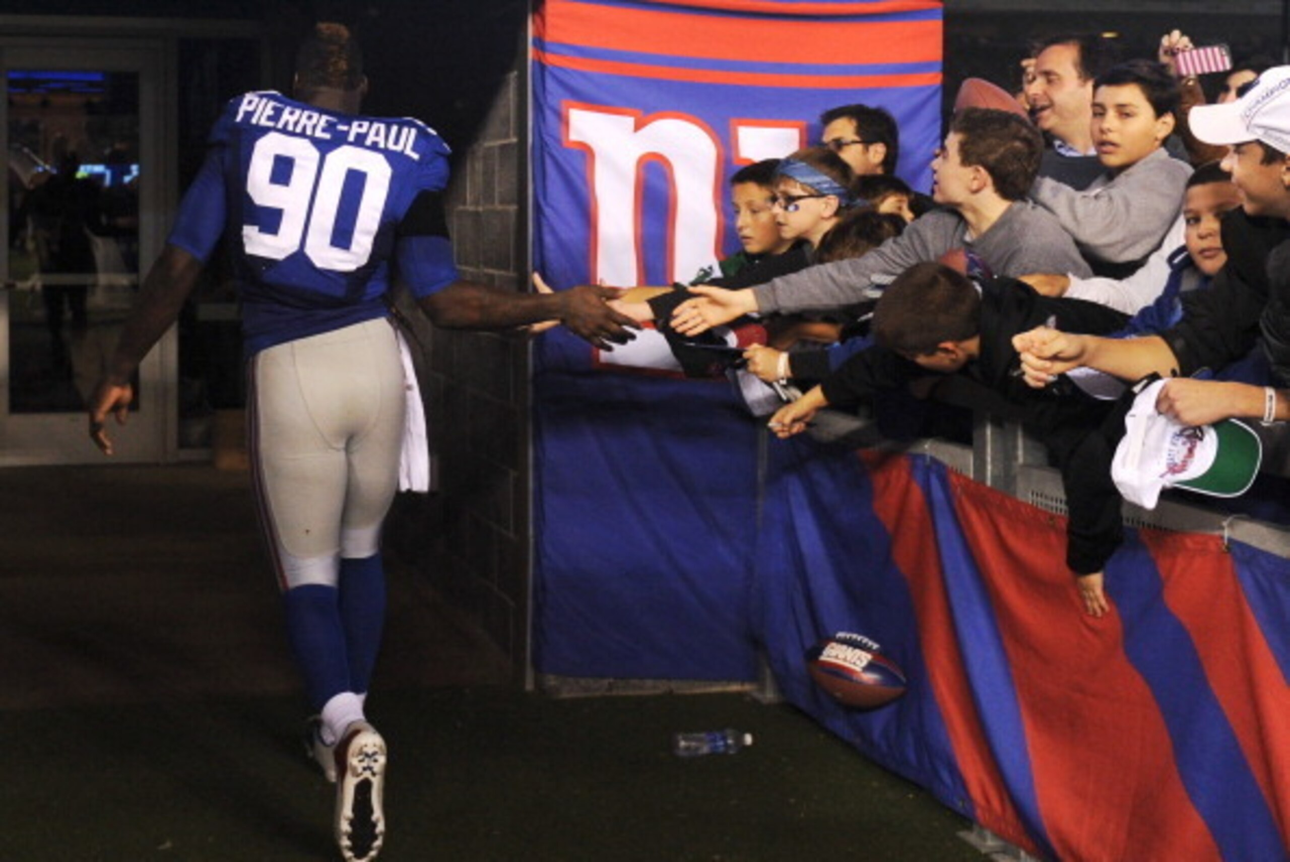 EAST RUTHERFORD, NJ - NOVEMBER 17: Jason Pierre-Paul #90 of the New York Giants shakes hands with fans following the game against the Green Bay Packers at MetLife Stadium on November 17, 2013 in East Rutherford, New Jersey. The Giants defeat the Packers EAST RUTHERFORD, NJ - NOVEMBER 17: Jason Pierre-Paul #90 of the New York Giants shakes hands with fans following the game against the Green Bay Packers at MetLife Stadium on November 17, 2013 in East Rutherford, New Jersey. The Giants defeat the Packers