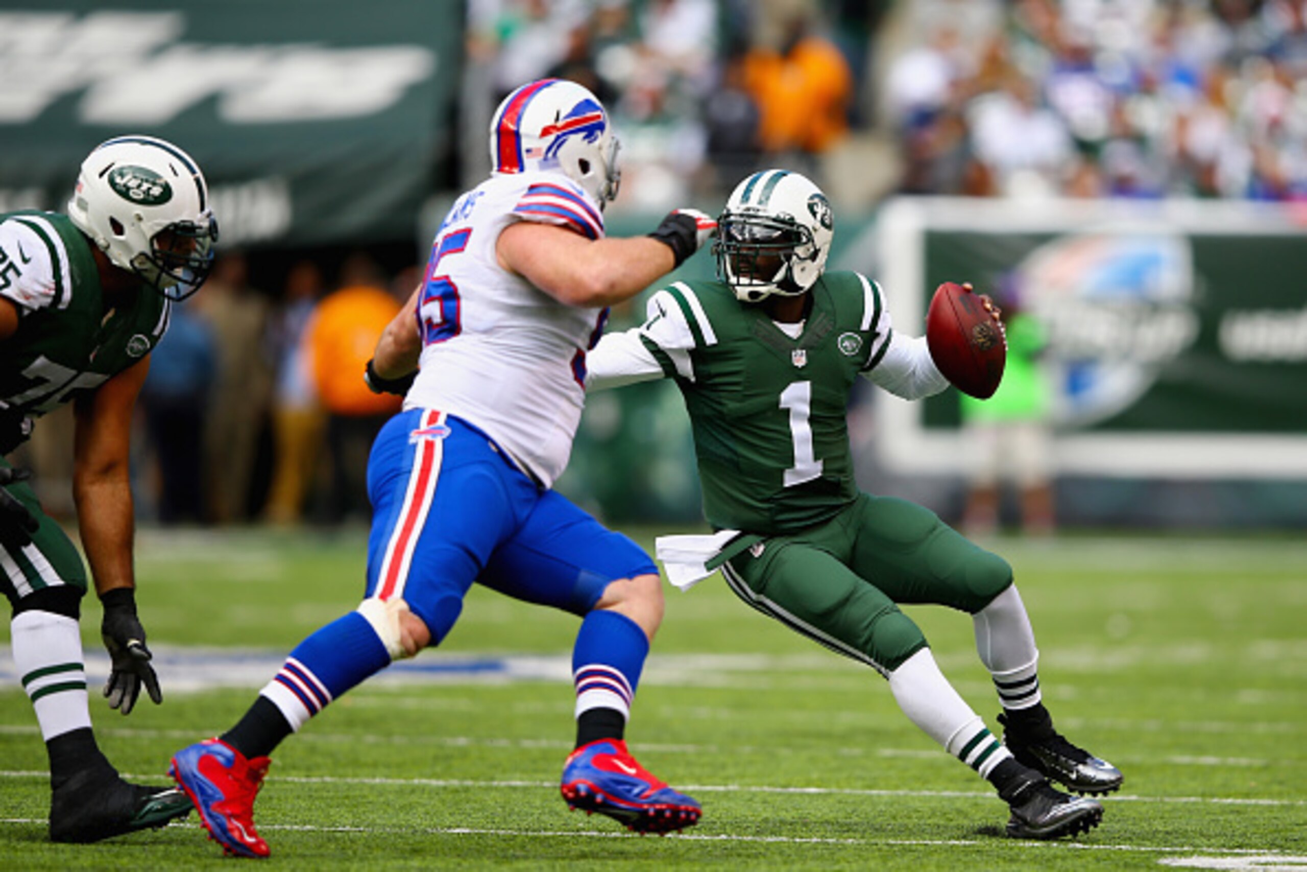 EAST RUTHERFORD, NJ - OCTOBER 26:  Quarterback  Michael Vick #1 of the New York Jets looks to pass against  Kyle Williams #95 of the Buffalo Bills in the first half of the game at MetLife Stadium on October 26, 2014 in East Rutherford, New Jersey.  (Photo