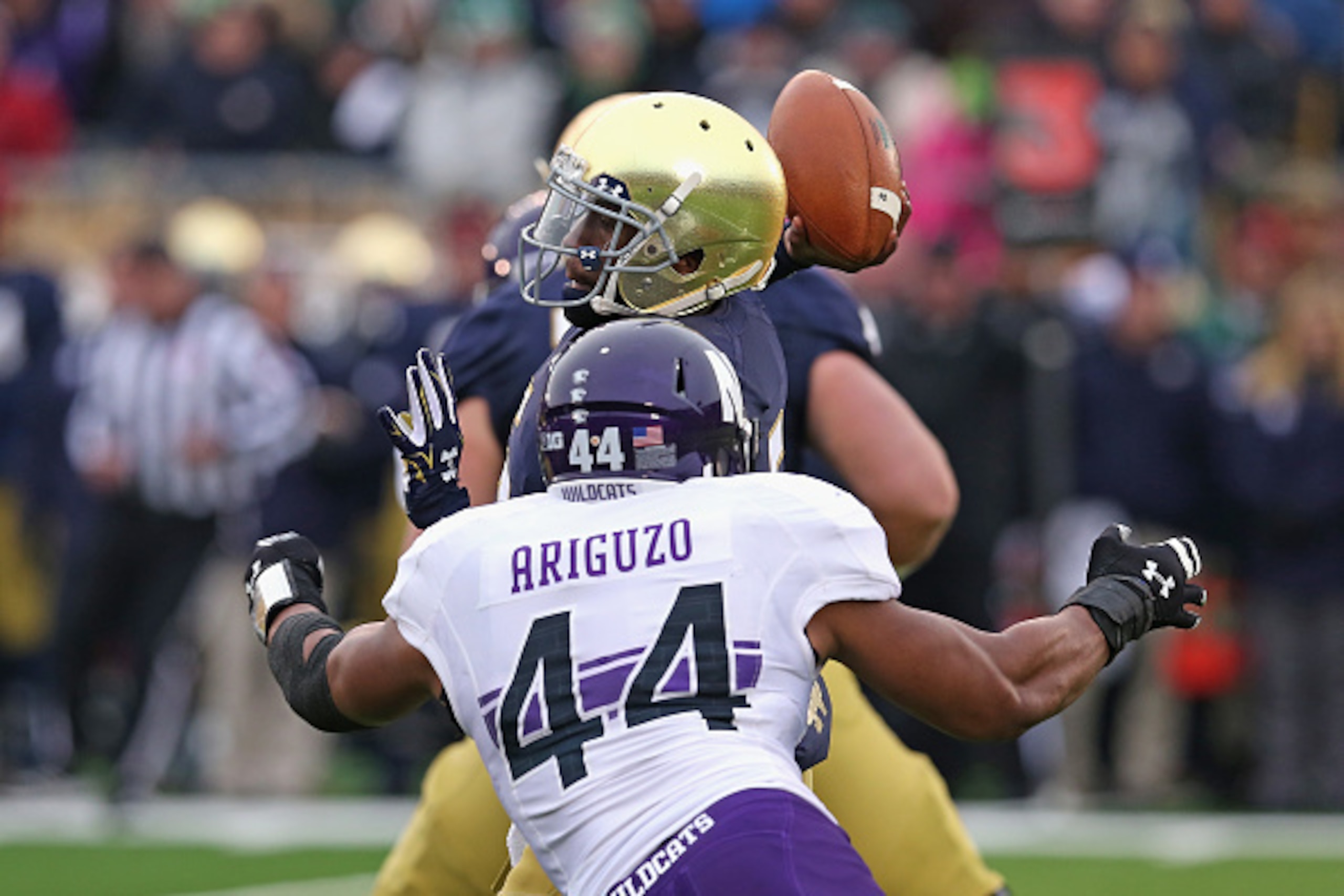 SOUTH BEND, IN - NOVEMBER 15:  Everett Golson #5 of the Notre Dame Fighting Irish passes under pressure from Chi Chi Ariguzo #44 of the Northwestern Wildcats at Notre Dame Stadium on November 15, 2014 in South Bend, Indiana.  (Photo by Jonathan Daniel/Get