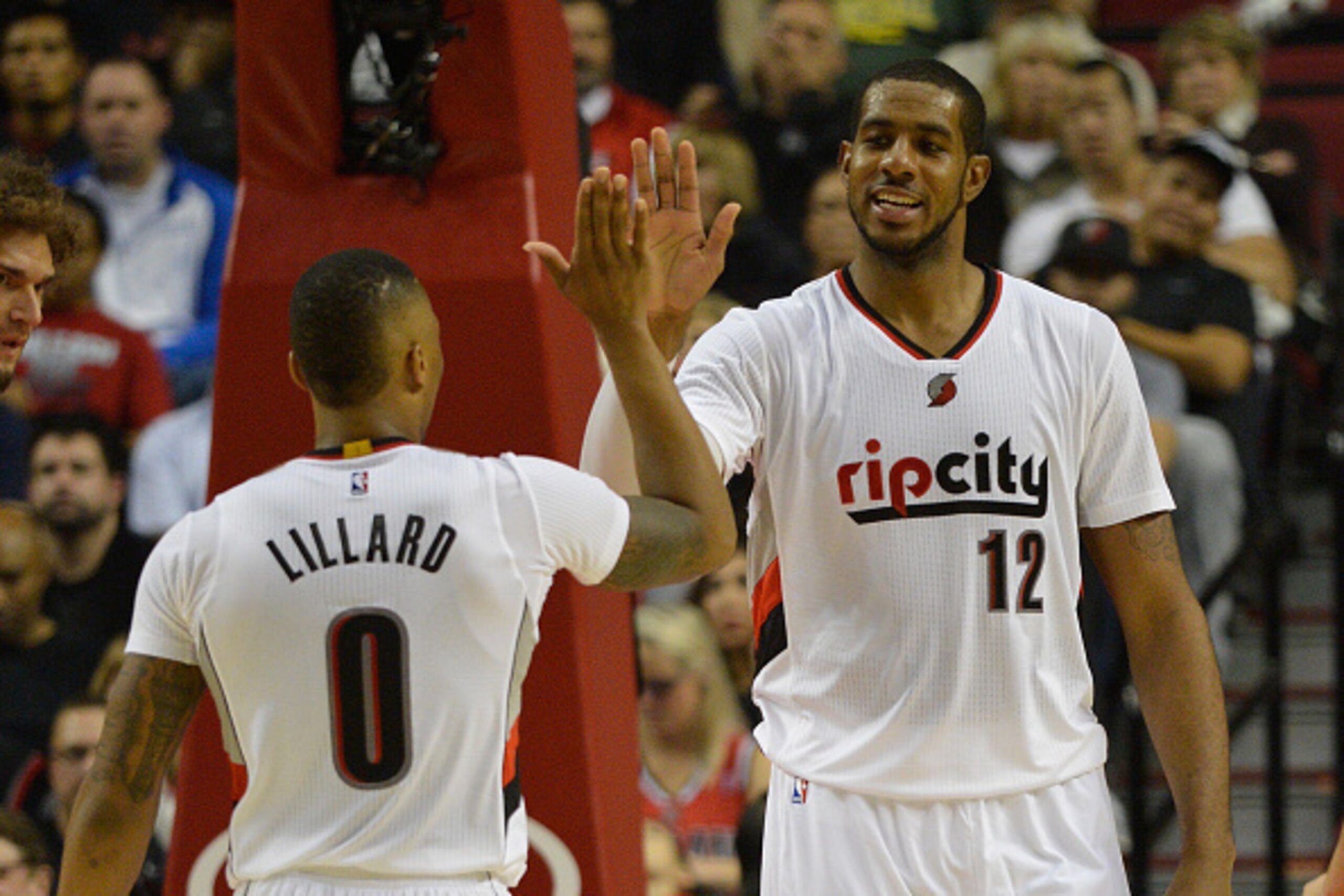 PORTLAND, OR - NOVEMBER 04: Damian Lillard #0 of the Portland Trail Blazers celebrates a basket by LaMarcus Aldridge #12 of the Portland Trail Blazers during the fourth quarter of the game against the Cleveland Cavaliers at Moda Center on November 4, 2014