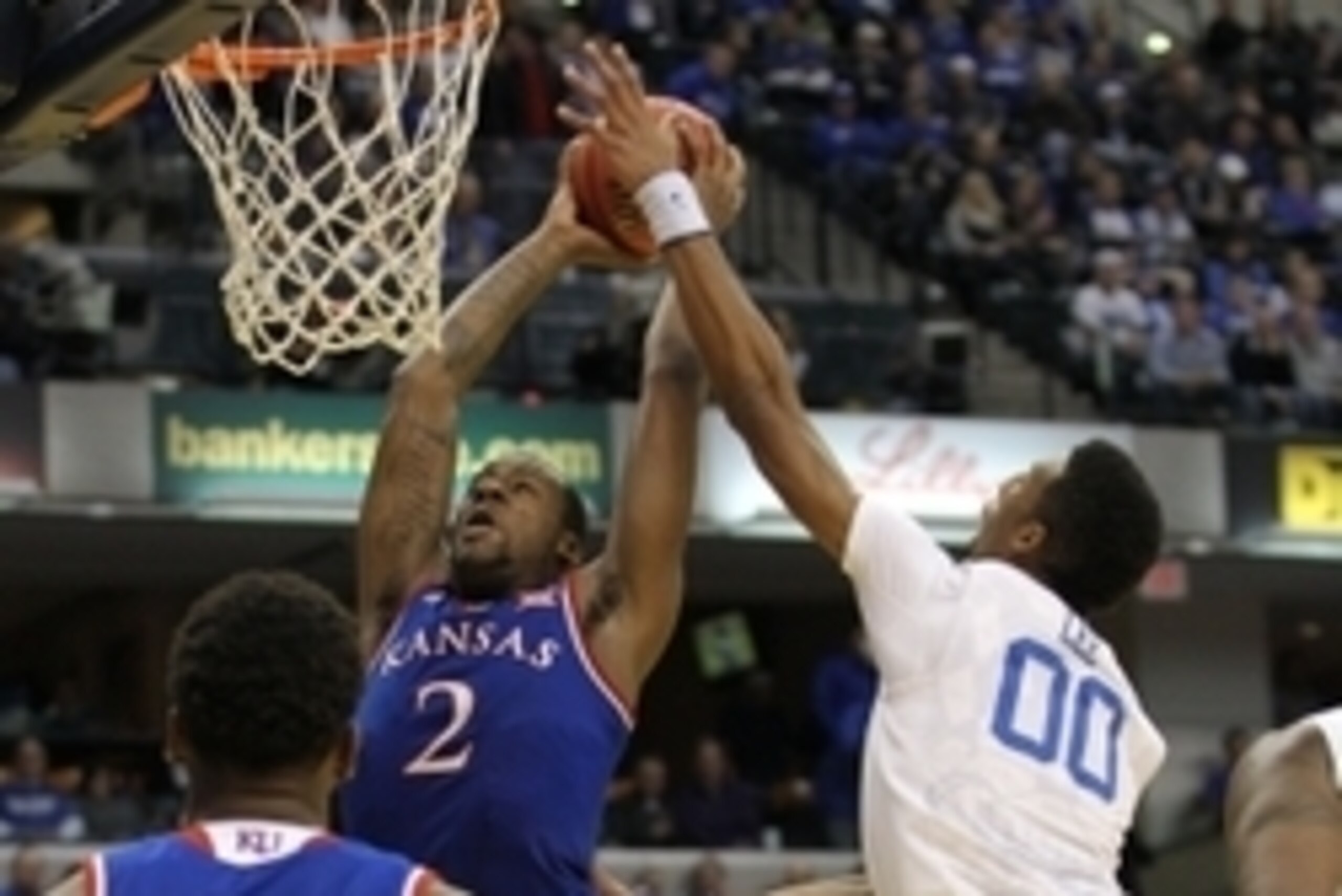 Nov 18, 2014; Indianapolis, IN, USA; Kentucky Wildcats forward Marcus Lee (00) contests a shot by Kansas Jayhawks forward Cliff Alexander (2) during the second half at Bankers Life Fieldhouse. Kentucky defeated Kansas 72-40. Mandatory Credit: Pat Lovell-U