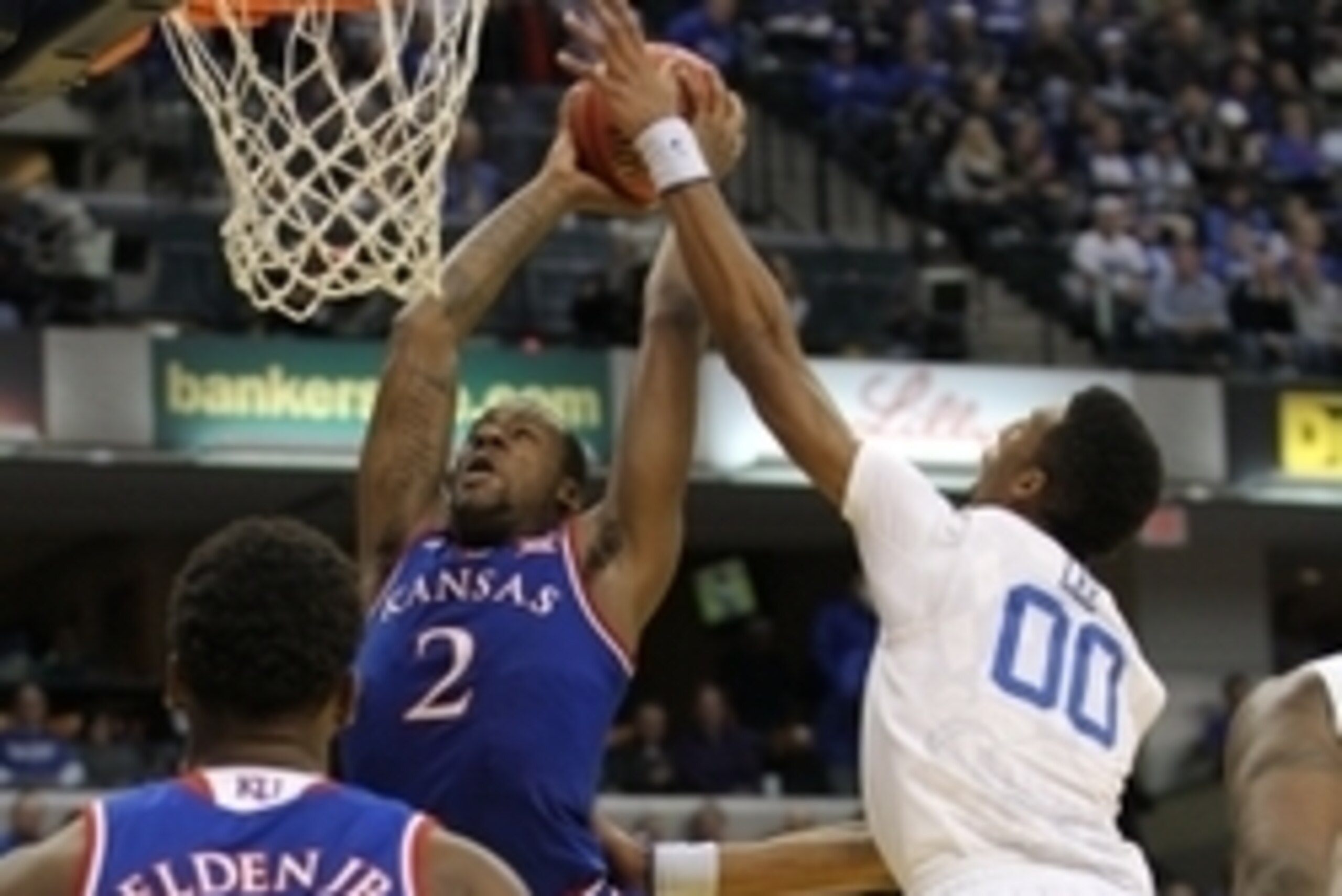 Nov 18, 2014; Indianapolis, IN, USA; Kentucky Wildcats forward Marcus Lee (00) contests a shot by Kansas Jayhawks forward Cliff Alexander (2) during the second half at Bankers Life Fieldhouse. Kentucky defeated Kansas 72-40. Mandatory Credit: Pat Lovell-U