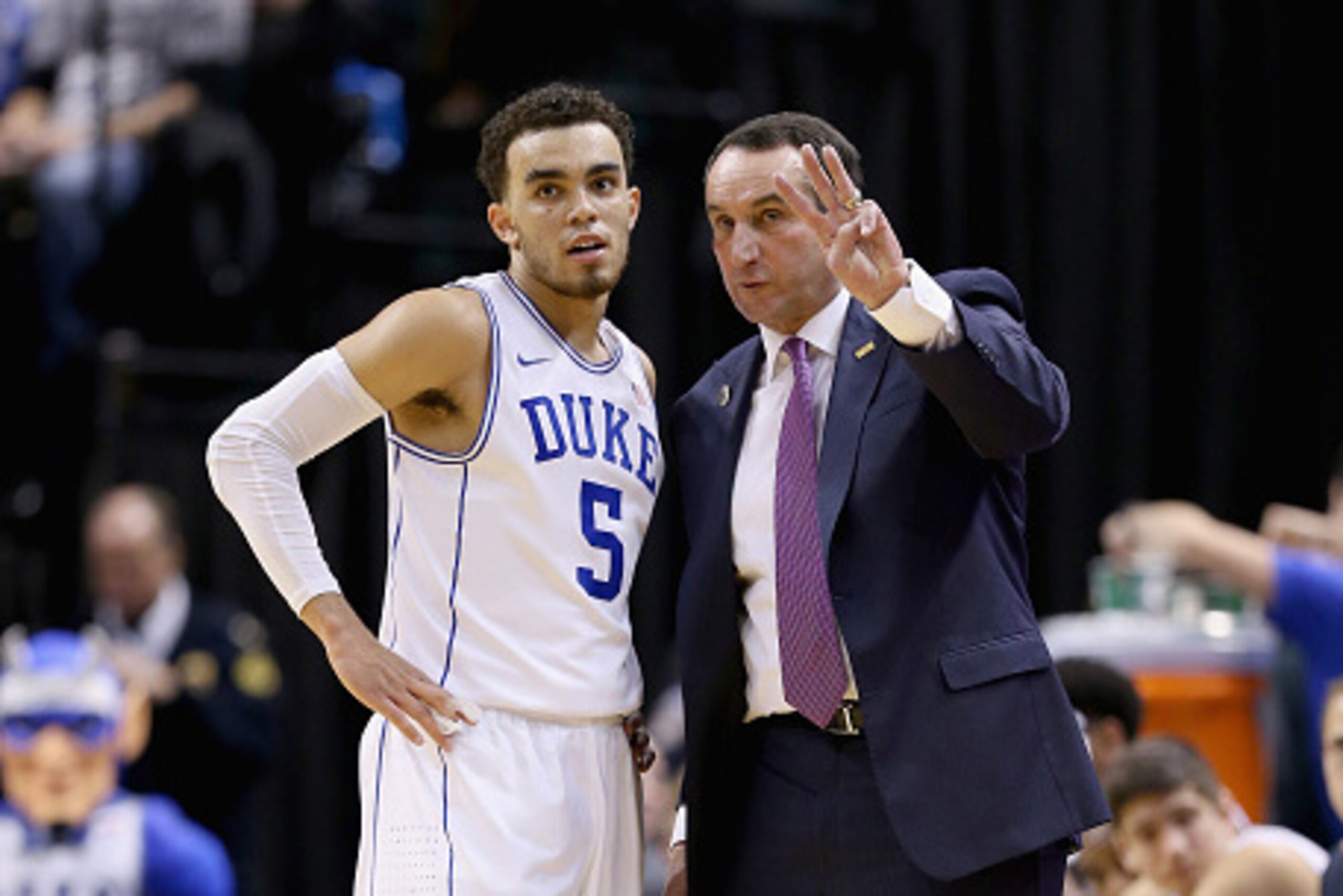 INDIANAPOLIS, IN - NOVEMBER 18:  Mike Krzyewski  the head coach of the Duke Blue Devils gives instructions to Tyus Jones #5 during the game against the Michigan State Spartans in the State Farm Champions Classic at Bankers Life Fieldhouse on November 18, 