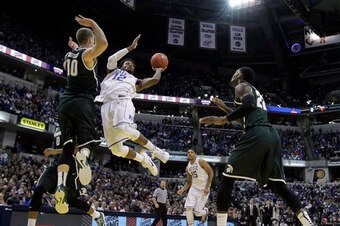 Justise Winslow hangs for the acrobatic layup.