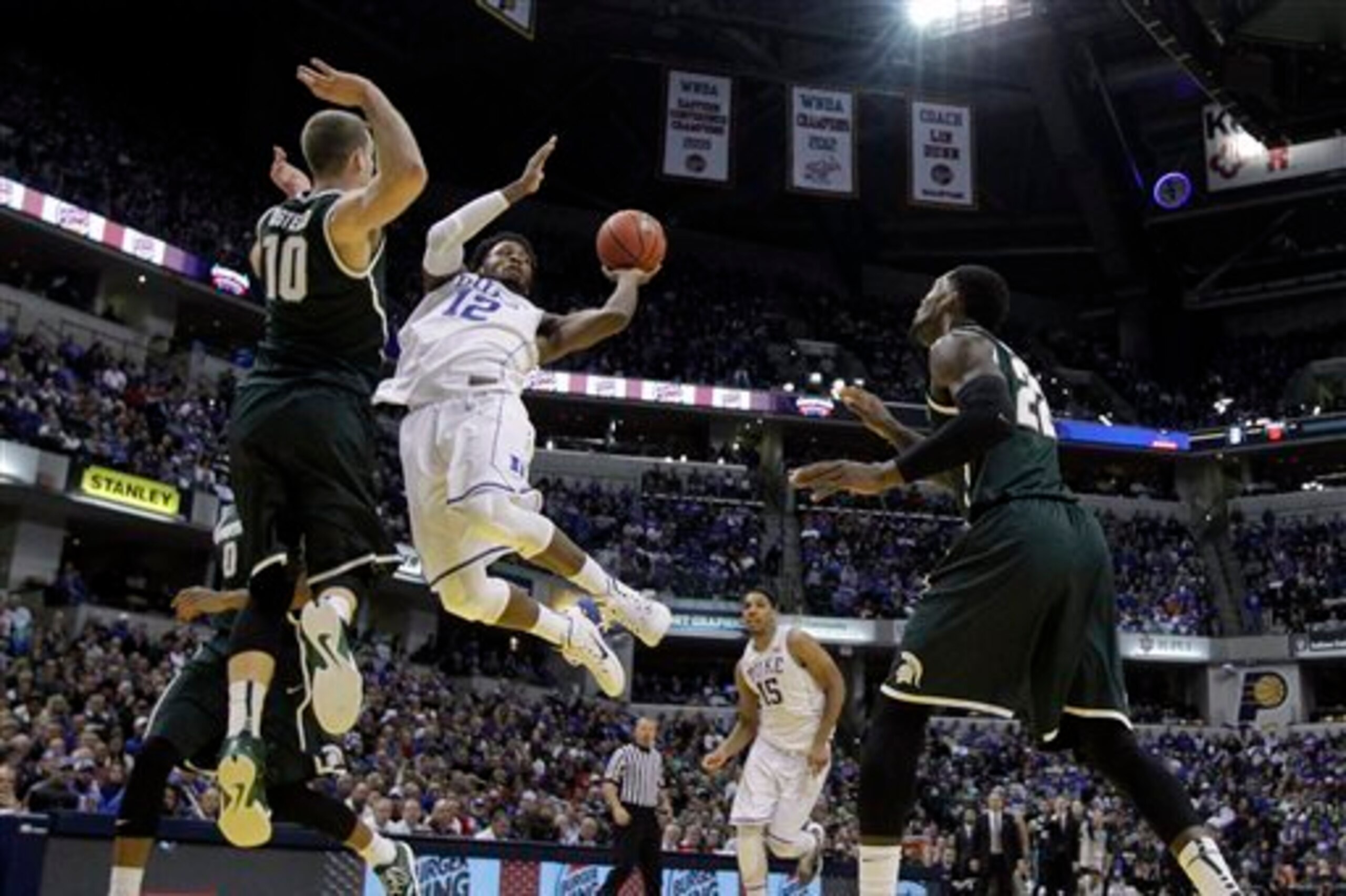 Justise Winslow hangs for the acrobatic layup.
