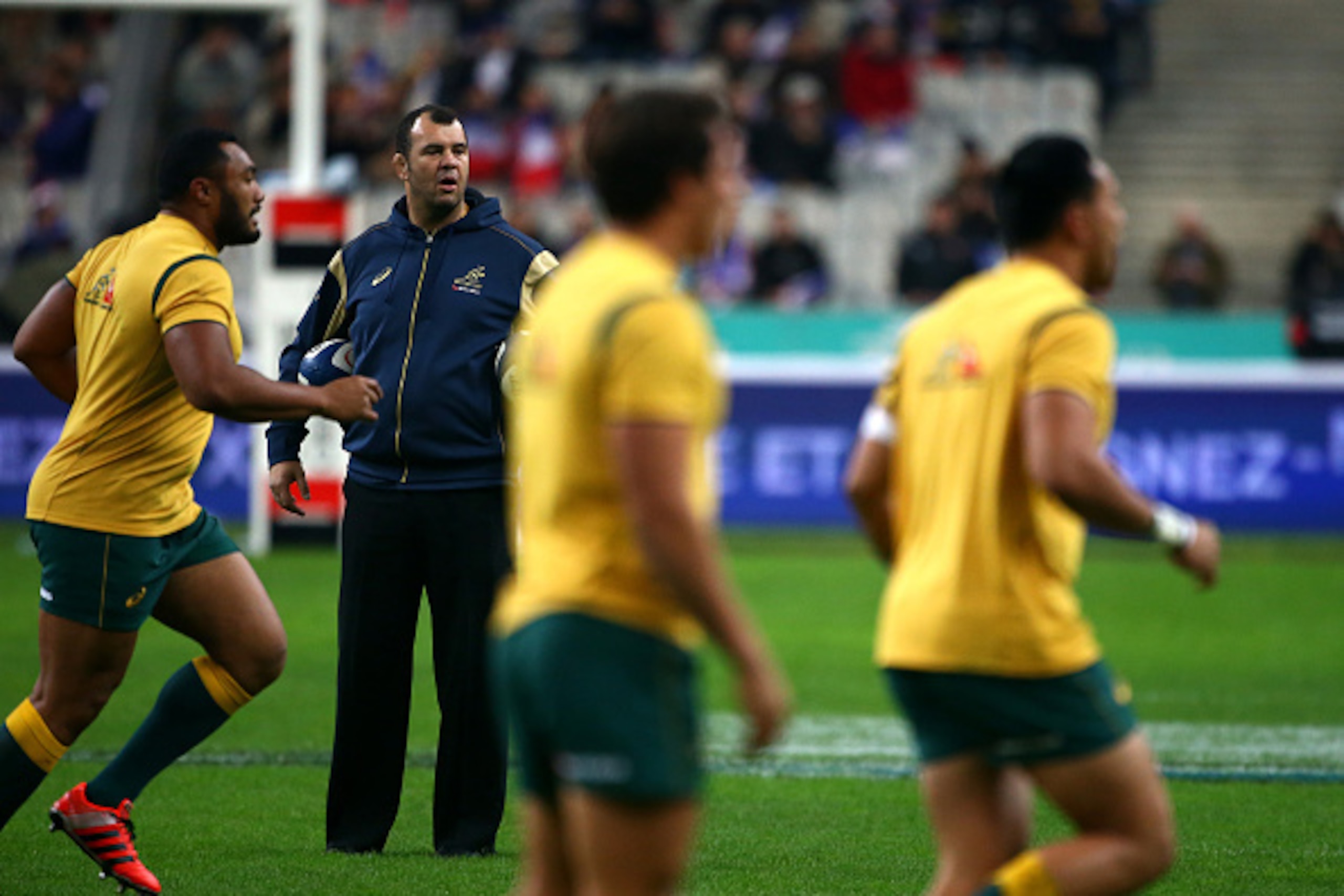 PARIS, FRANCE - NOVEMBER 15: Australia head coach Michael Cheika keeps an eye on the warm up during the International match between France and Australia at The Stade De France on November 15, 2014 in Paris, France. (Photo by Charlie Crowhurst/Getty Images