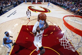 CLEVELAND, OH - NOVEMBER 17: LeBron James #23 of the Cleveland Cavaliers goes up for a dunk against the Denver Nuggets during the game on November 17, 2014 at Quicken Loans Arena in Cleveland, Ohio. NOTE TO USER: User expressly acknowledges and agrees tha
