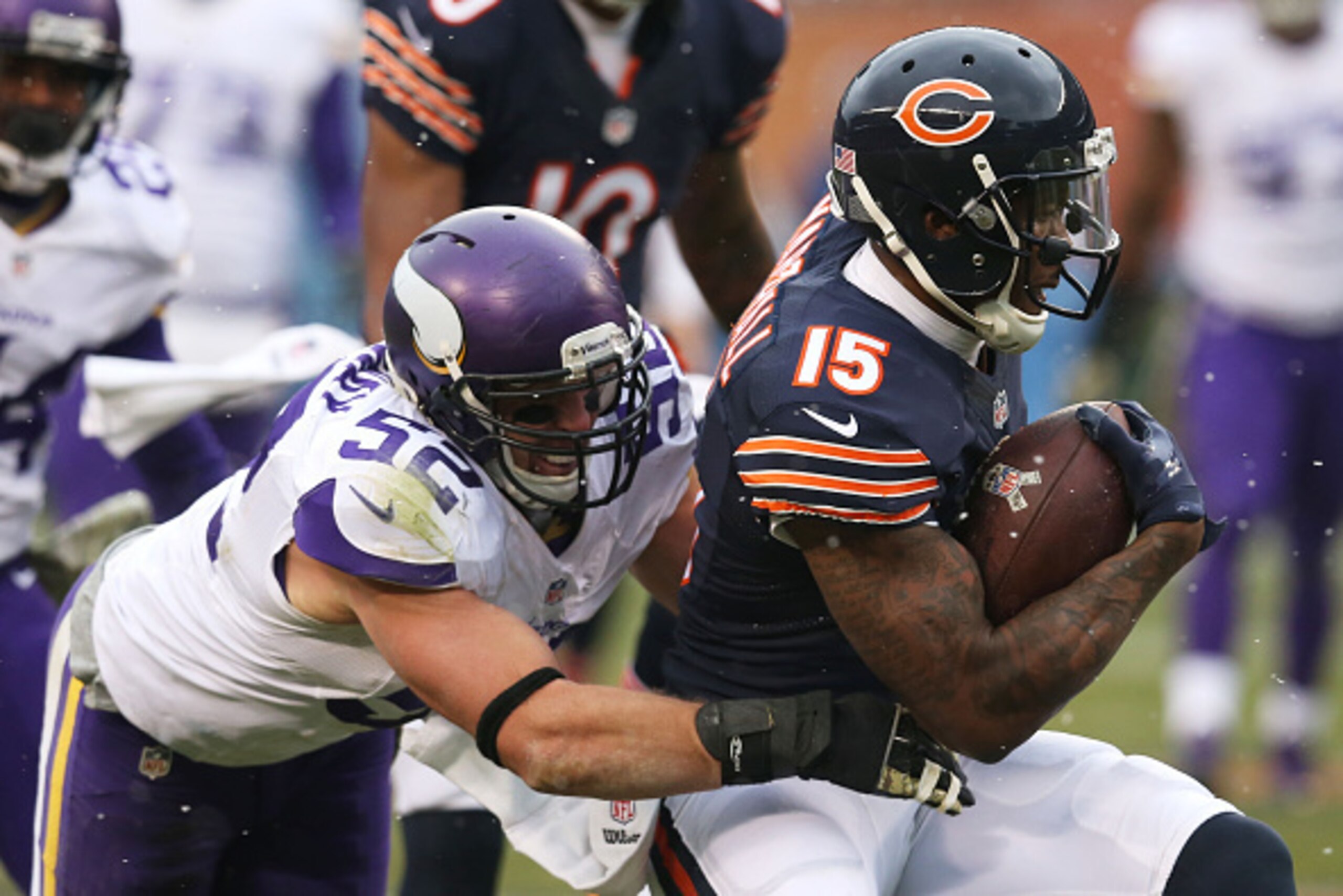 CHICAGO, IL - NOVEMBER 16:  Brandon Marshall #15 of the Chicago Bears is tackled by Chad Greenway #52 of the Minnesota Vikings during the first half of a game at Soldier Field on November 16, 2014 in Chicago, Illinois. The Bears defeated the Vikings 21-13