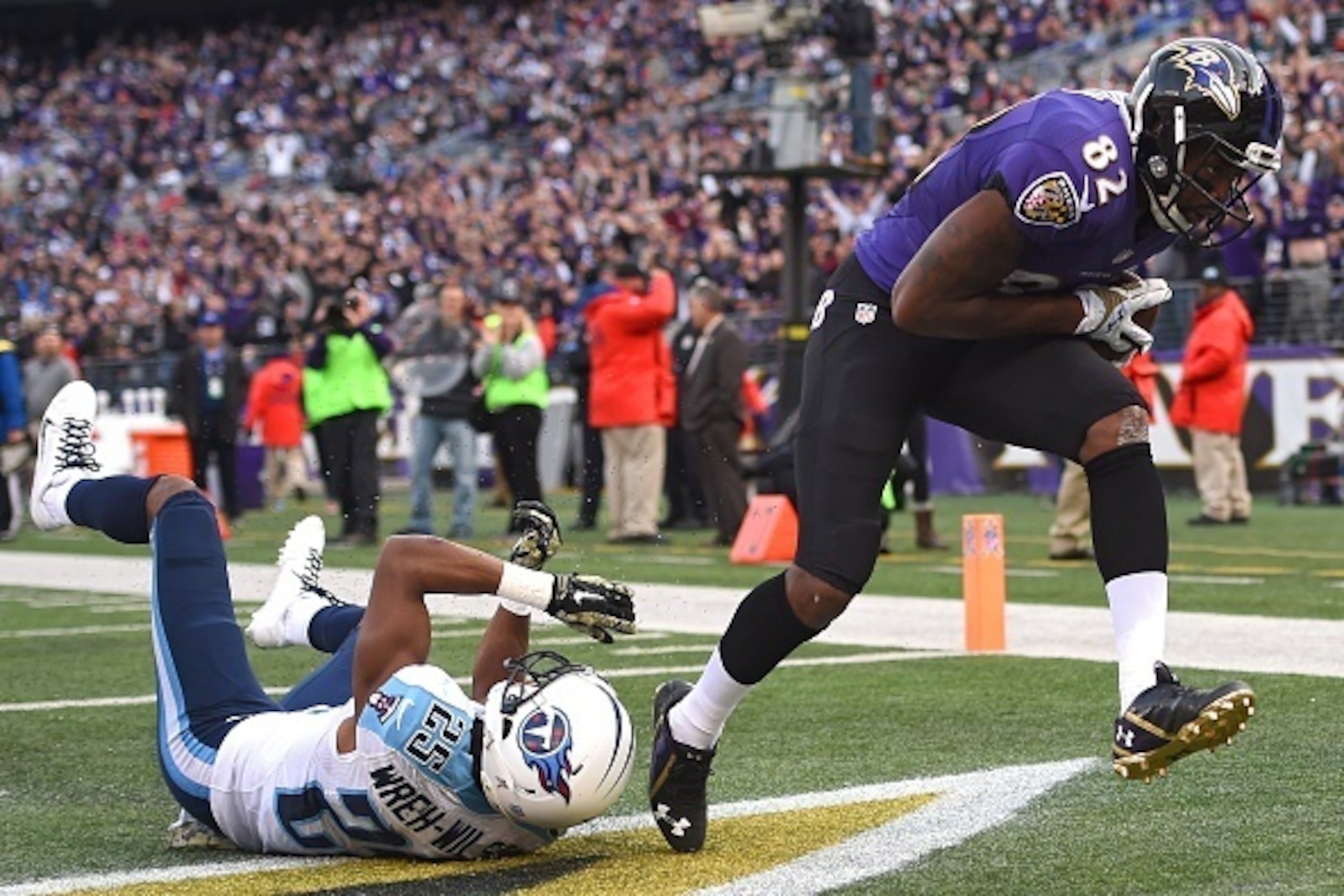 BALTIMORE, MD - NOVEMBER 09: Wide receiver Torrey Smith #82 of the Baltimore Ravens catches a 4th quarter touchdown past cornerback Blidi Wreh-Wilson #25 of the Tennessee Titans at M&T Bank Stadium on November 9, 2014 in Baltimore, Maryland. (Photo by Pat