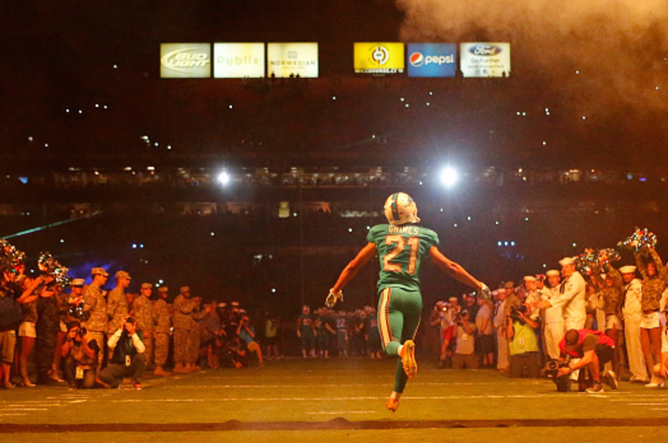 MIAMI GARDENS, FL - NOVEMBER 13:  Cornerback Brent Grimes #21 of the Miami Dolphins runs onto the field before his team met the Buffalo Bills in a game at Sun Life Stadium on November 13, 2014 in Miami Gardens, Florida.  (Photo by Joel Auerbach/Getty Imag