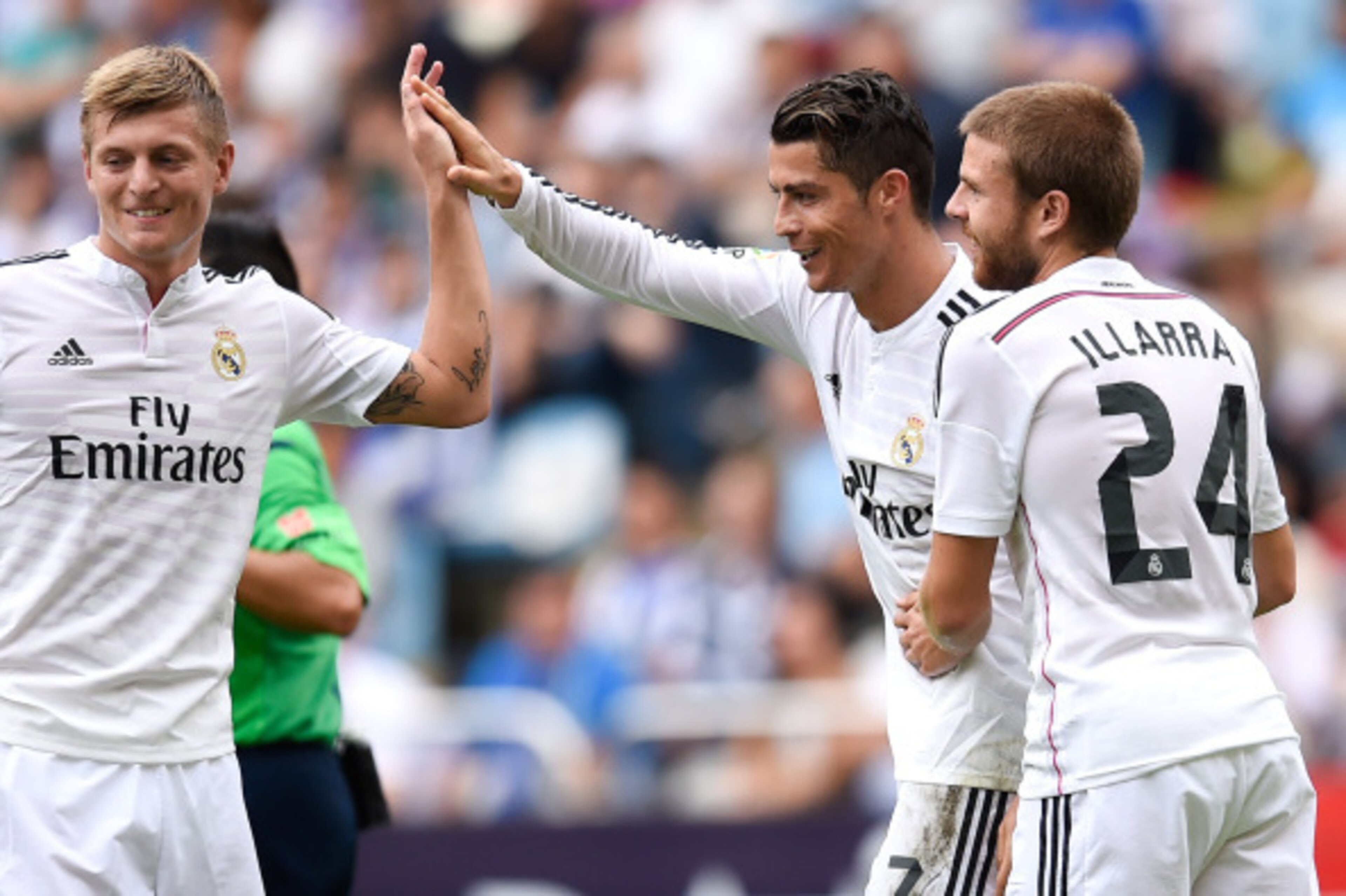 LA CORUNA, SPAIN - SEPTEMBER 20:  Cristiano Ronaldo of Real Madrid CF celebrates with his teammates Toni Kroos (L) and Asier Illarramendi after scoring his team's sixth goal during the La Liga match between RC Deportivo La Coruna and Real Madrid CF at Ria