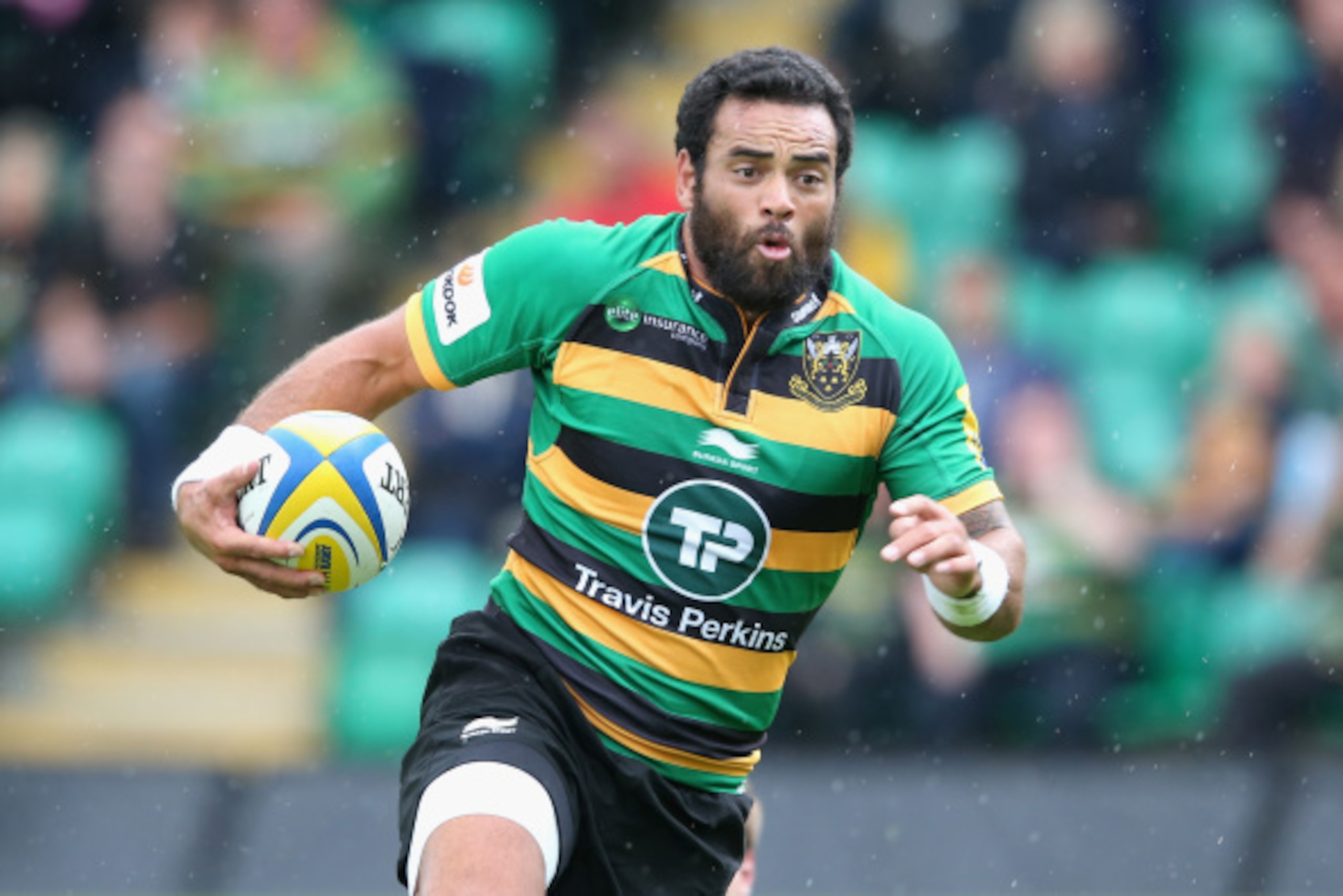 NORTHAMPTON, ENGLAND - AUGUST 23:  Kahn Fotuali'i of Northampton runs with the ball during the pre season friendly match between Northampton Saints and Leinster at Franklin's Gardens on August 23, 2014 in Northampton, England.  (Photo by David Rogers/Gett