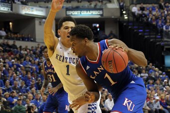 Nov 18, 2014; Indianapolis, IN, USA; Kansas Jayhawks guard Wayne Selden Jr. (1) dribbles the ball around Kentucky Wildcats guard Devin Booker (1) during the second half at Bankers Life Fieldhouse. Kentucky defeated Kansas 72-40. Mandatory Credit: Pat Love