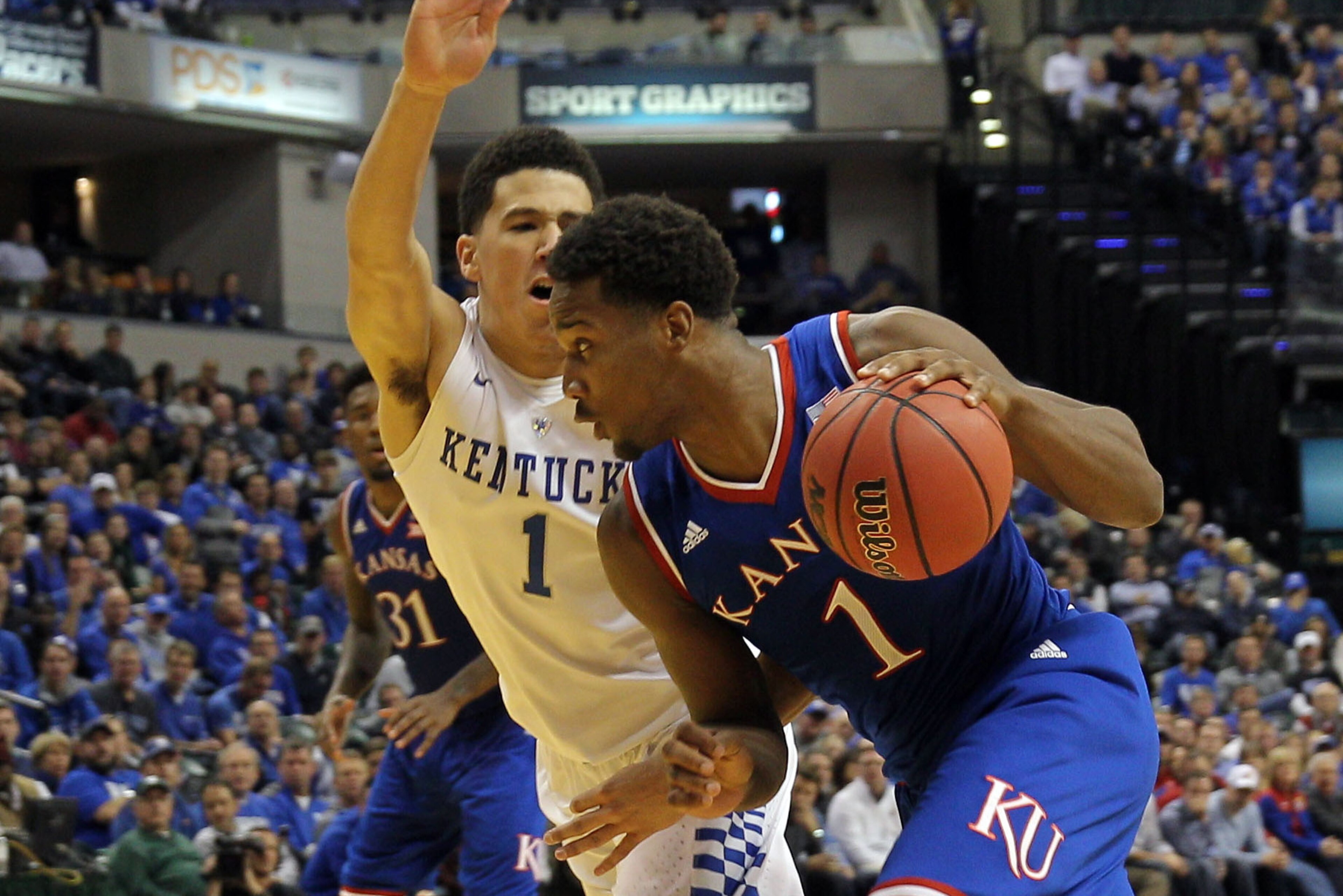 Nov 18, 2014; Indianapolis, IN, USA; Kansas Jayhawks guard Wayne Selden Jr. (1) dribbles the ball around Kentucky Wildcats guard Devin Booker (1) during the second half at Bankers Life Fieldhouse. Kentucky defeated Kansas 72-40. Mandatory Credit: Pat Love