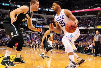 Nov 18, 2014; Indianapolis, IN, USA; Duke Blue Devils center Jahlil Okafor (15) drives against  Michigan State Spartans forward Matt Costello (10) in the 2nd half of the State Farm Champions Classic at Bankers Life Fieldhouse. Mandatory Credit: Porter Bin