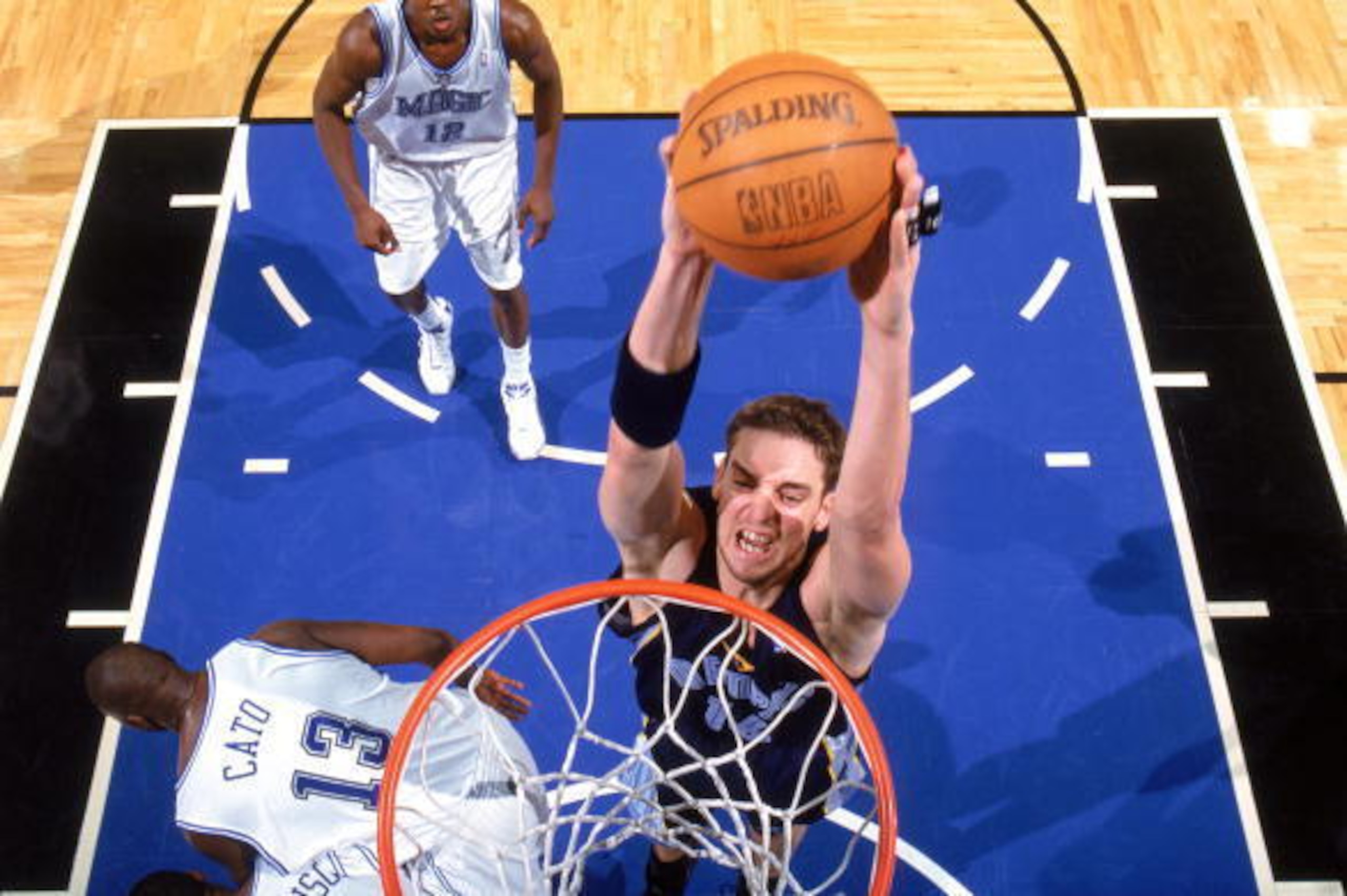 ORLANDO, FL - DECEMBER 4: Pau Gasol #16 of the Memphis Grizzlies goes to the basket over Kelvin Cato #13 of the Orlando Magic during a game at TD Waterhouse Centre on December 4, 2004 in Orlando, Florida. The Magic won 96-91. NOTE TO USER: User expressl ORLANDO, FL - DECEMBER 4: Pau Gasol #16 of the Memphis Grizzlies goes to the basket over Kelvin Cato #13 of the Orlando Magic during a game at TD Waterhouse Centre on December 4, 2004 in Orlando, Florida. The Magic won 96-91. NOTE TO USER: User expressl