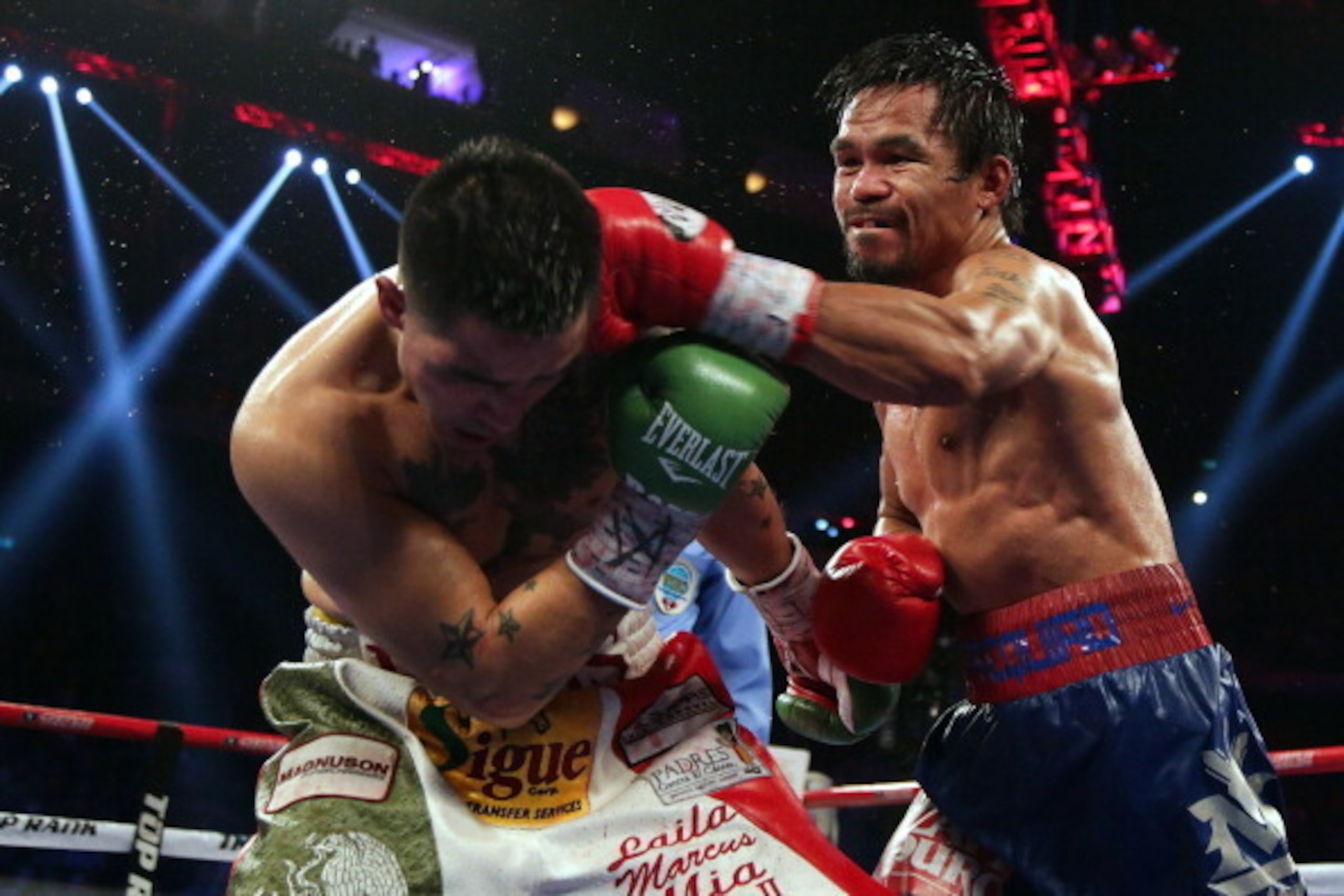 MACAU - NOVEMBER 24:  Manny Pacquiao (R) of the Philippines punches Brandon Rios of the U.S. during their 'Clash in Cotai' WBO International Welterweight title fight on November 24, 2013 in Macau.  (Photo by Nicky Loh/Getty Images)