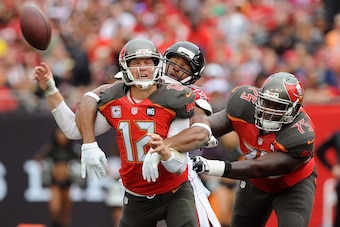 TAMPA, FL - NOVEMBER 09: Josh McCown #12 of the Tampa Bay Buccaneers is hit by Osi Umenyiora #50 of the Atlanta Falcons during the first quarter of the game at Raymond James Stadium on November 9, 2014 in Tampa, Florida. (Photo by Cliff McBride/Getty Imag
