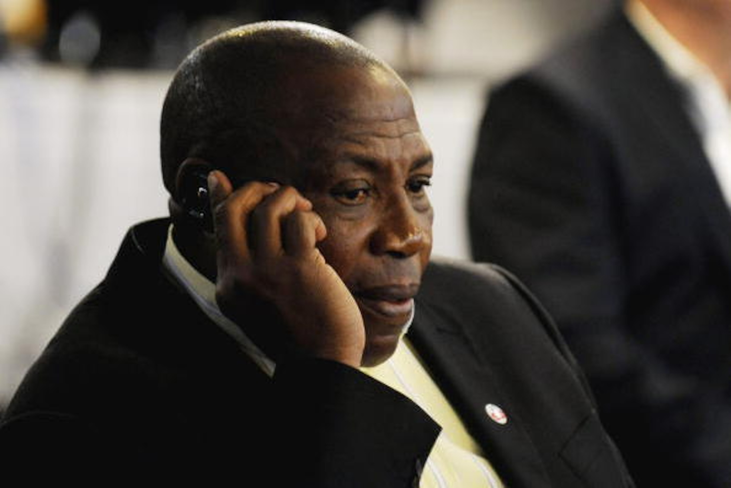 JOHANNESBURG, SOUTH AFRICA - AUGUST 05: Shakes Mashaba, the South African under 23 coach speaks on the phone during the Bafana Bafana team announcement held at SAFA House Conference Room, Nasrec on August 05, 2010 in Johannesburg, South Africa. (Photo by 