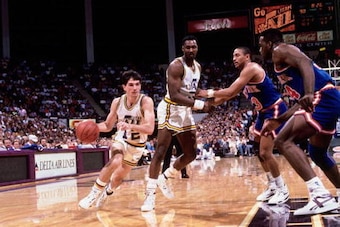 SALT LAKE CITY - 1989:  John Stockton #12 of the Utah Jazz drives to the basket around a Karl Malone #32 pick against the New York Knicks circa 1989 at the Delta Center in Salt Lake City, Utah. NOTE TO USER: User expressly acknowledges and agrees that, by