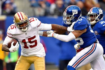 EAST RUTHERFORD, NJ - NOVEMBER 16:  Michael Crabtree #15 of the San Francisco 49ers breaks free from  Quintin Demps #35 of the New York Giants on his way to scoring a touchdown in the third quarter at MetLife Stadium on November 16, 2014 in East Rutherfor