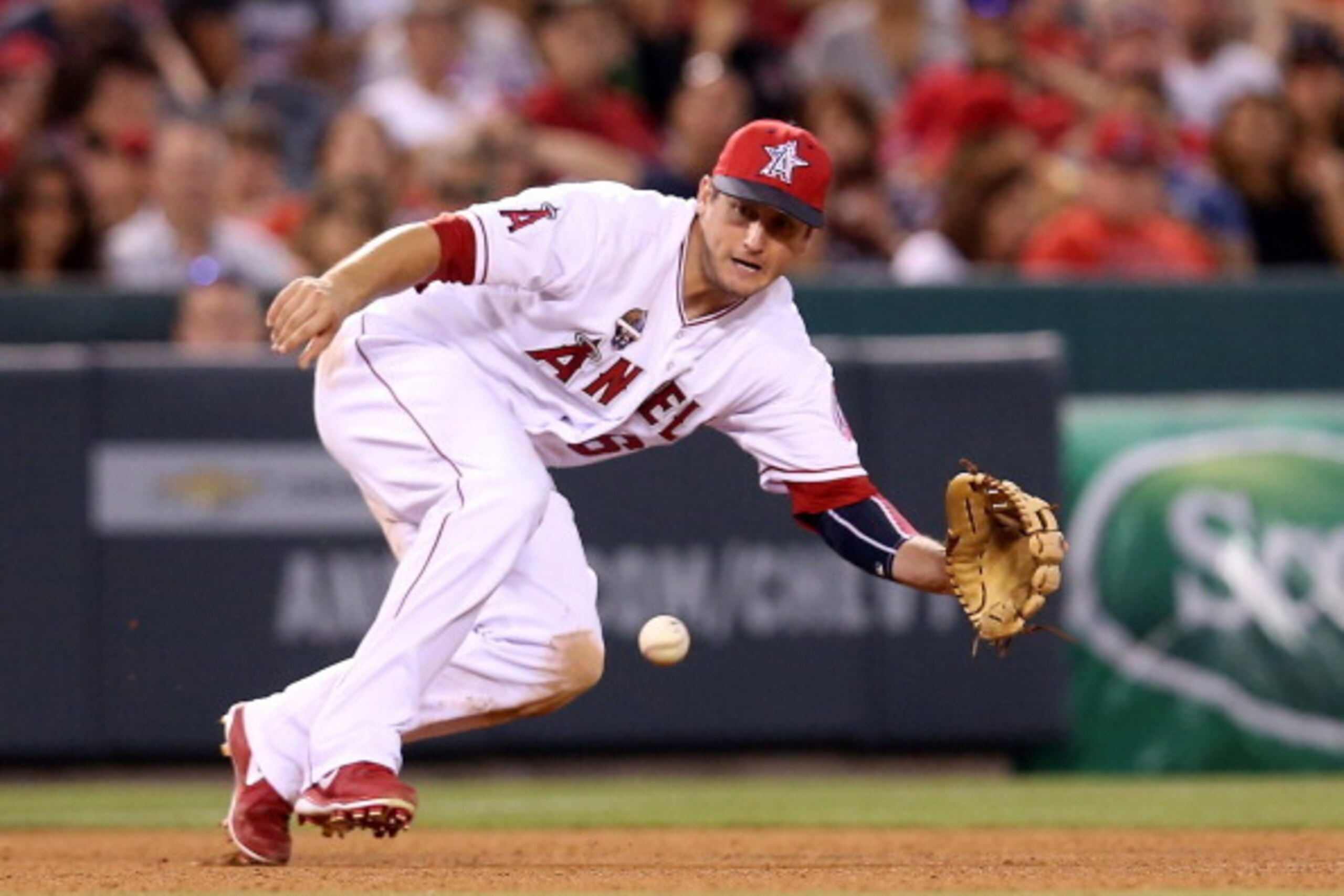 ANAHEIM, CA - JULY 04:   Third baseman David Freese #6 of the Los Angeles Angels of Anaheim dives to field a ground ball hit by L.J. Hoes of the Houston Astros for the first out of the seventh inning at Angel Stadium of Anaheim on July 4, 2014 in Anaheim,
