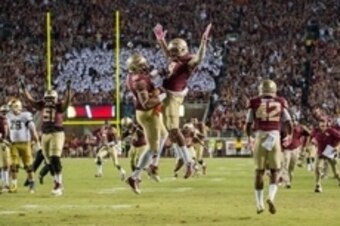 Oct 18, 2014; Tallahassee, FL, USA; Florida State Seminoles linebacker Jacob Pugh (16) celebrates with running back Karlos Williams (9) after an interception in the fourth quarter against the Notre Dame Fighting Irish at Doak Campbell Stadium. Florida Sta