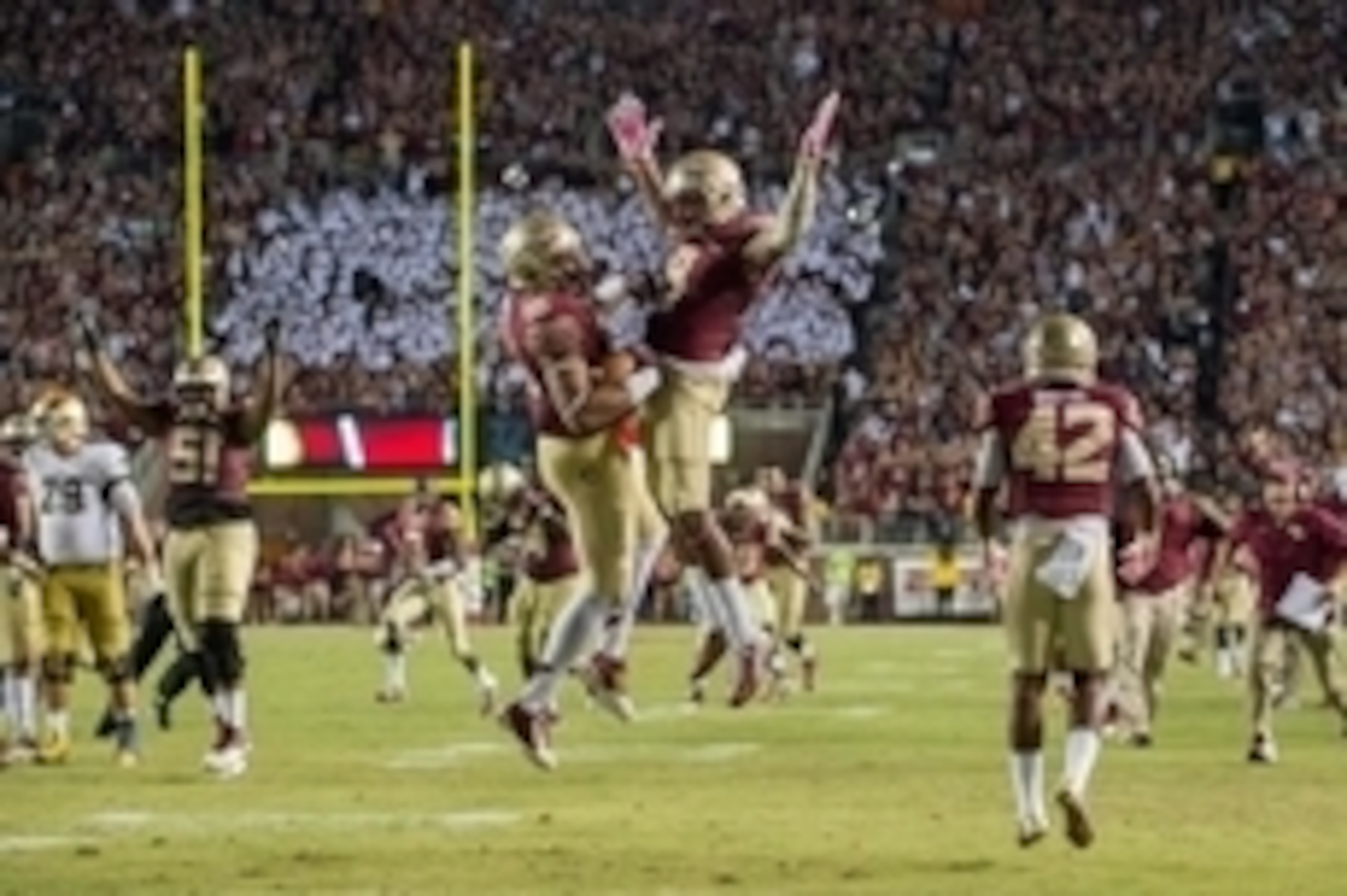 Oct 18, 2014; Tallahassee, FL, USA; Florida State Seminoles linebacker Jacob Pugh (16) celebrates with running back Karlos Williams (9) after an interception in the fourth quarter against the Notre Dame Fighting Irish at Doak Campbell Stadium. Florida Sta